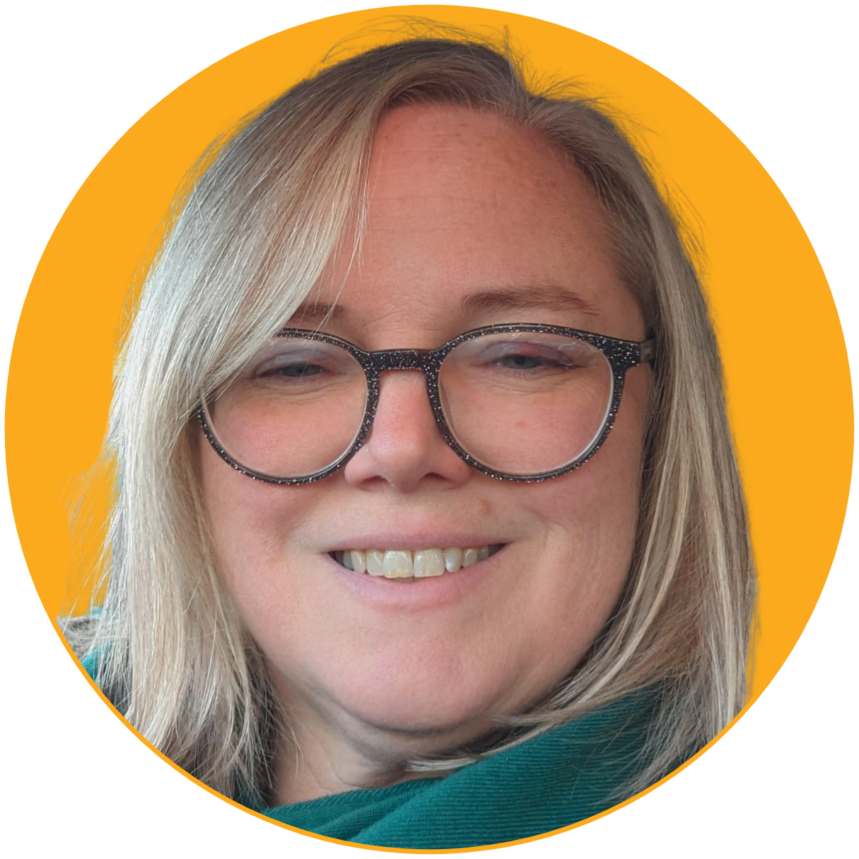 Close-up of a smiling woman with blonde hair, glasses, and a yellow background.