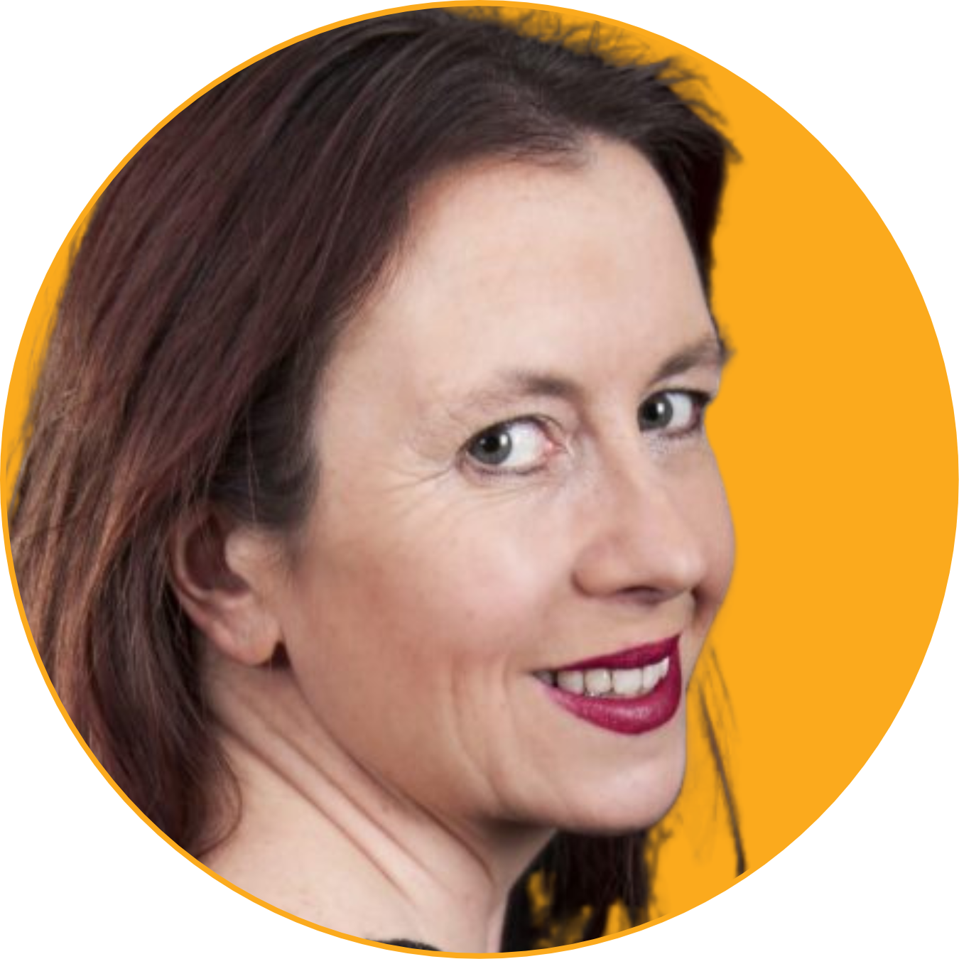 Close-up of a woman with shoulder-length reddish-brown hair at the camera against a black and yellow background.
