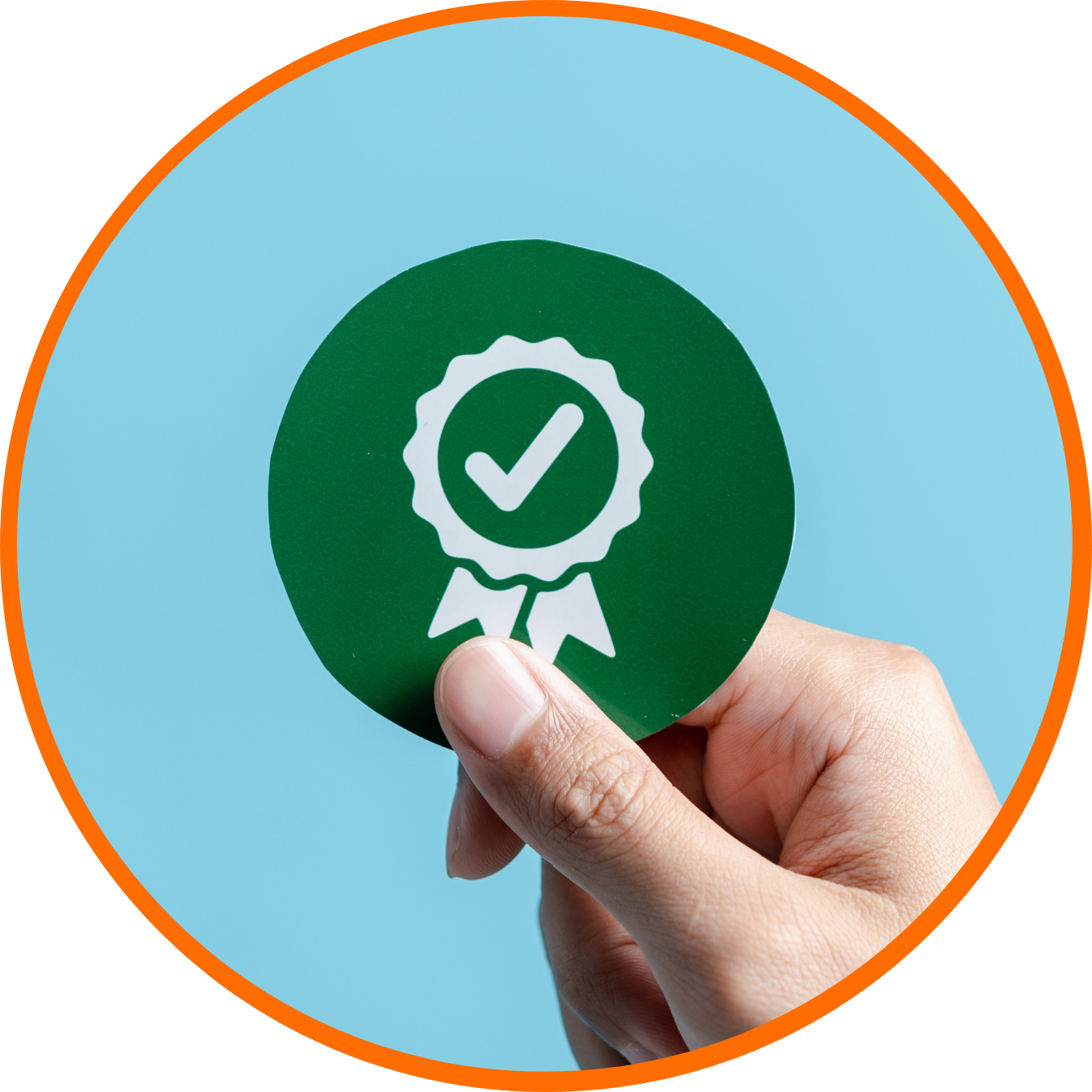 Hand holding a green circular badge with a checkmark inside a ribbon icon, symbolizing certification or approval.