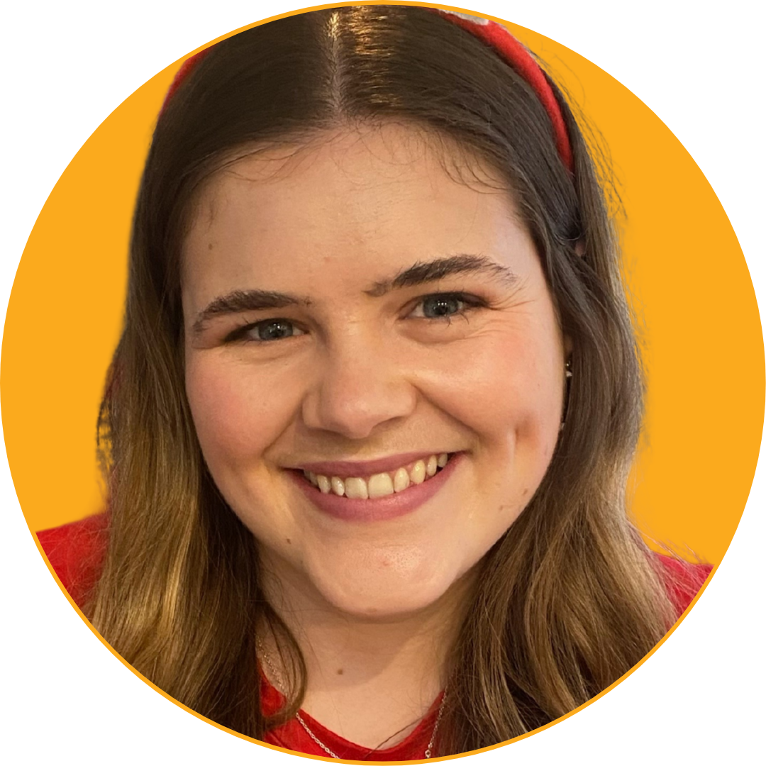 Smiling young woman with long brown hair, blue eyes, red headband, wearing a red top, against a yellow background.