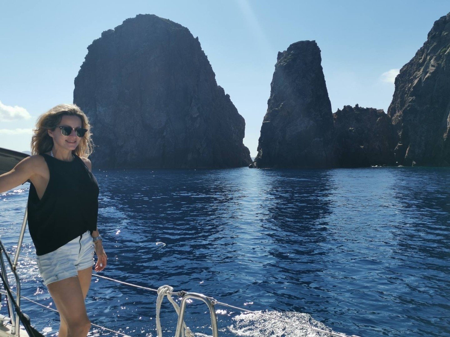 🧿Throwback Thursday takes us to a favorite moment with our founder, @katerina.fragkou.adai, as she navigates the tranquil Mediterranean waters. Here, she's in search of the perfect new spot, amidst majestic remote rock formations. This journey is ju