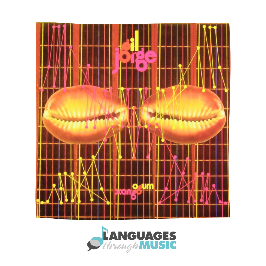 Bright, colorful album cover featuring two large shell images in the center, surrounded by a grid and multiple colorful lines and dots. The text 'jorge' appears in pink near the top center, and the words 'volume' and 'dango' are in yellow and pink at the bottom. The logo of 'Languages through Music' is at the bottom.