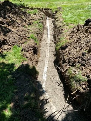 Existing sump pump discharge line before drainage improvements and replacement.