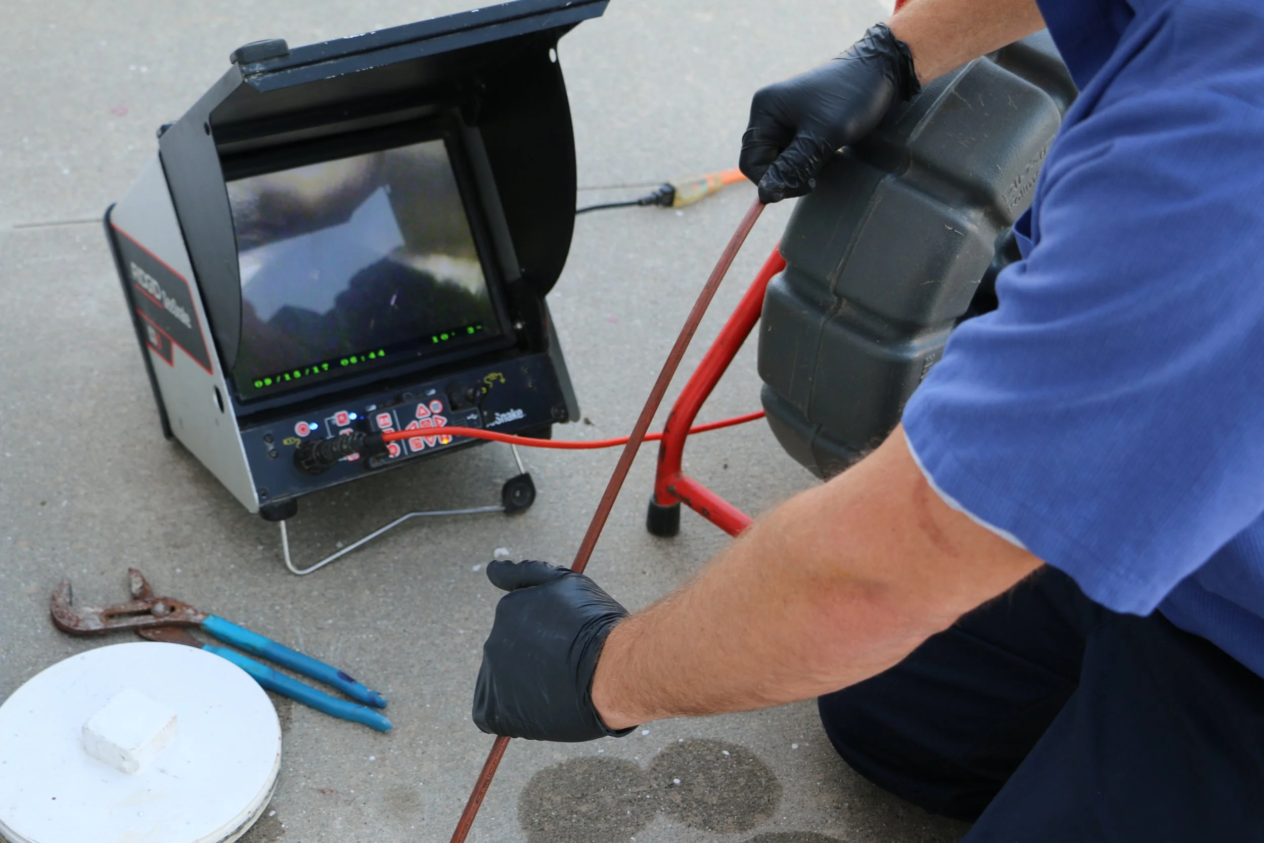 Universal Plumbing & Sewer technician performing a sewer line camera inspection to locate drain line damage, blockages, and sewer system issues.