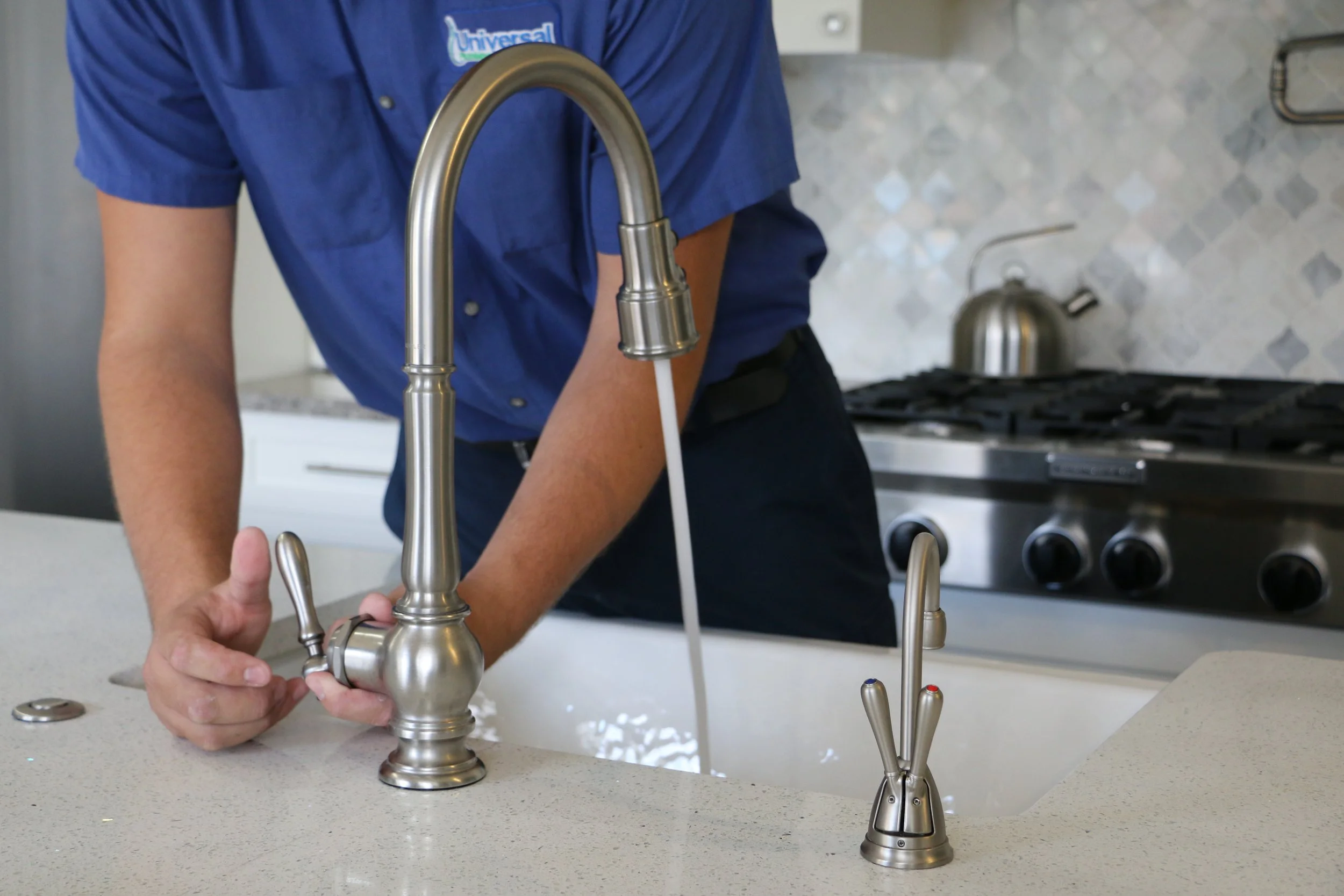 Universal Plumbing & Sewer technician repairing a kitchen faucet to fix leaks and improve water efficiency.