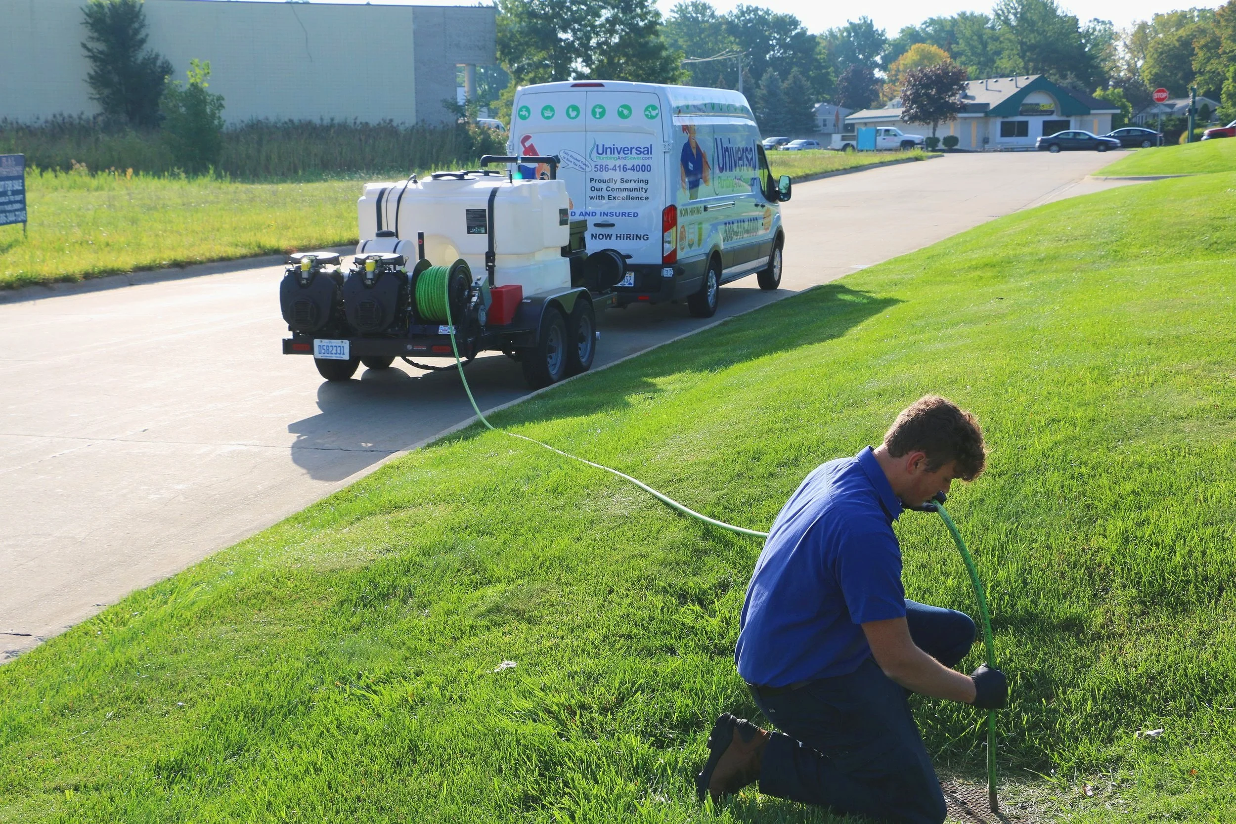 Universal Plumbing & Sewer technician performing high-pressure sewer jetting to clear a clogged sewer line and restore proper drainage.