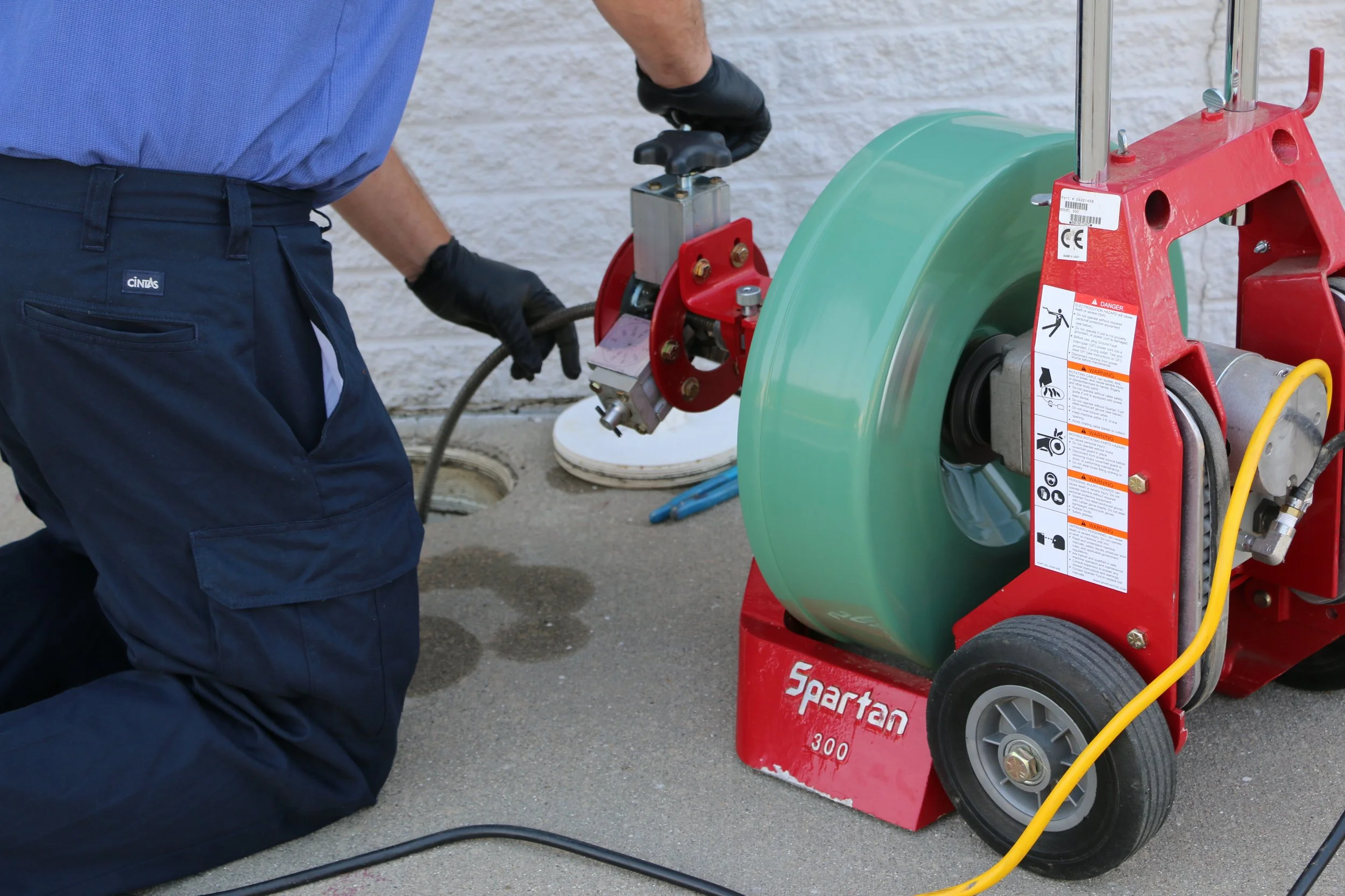 Universal Plumbing & Sewer technician using professional drain cleaning equipment to remove clogs and restore proper drain flow.