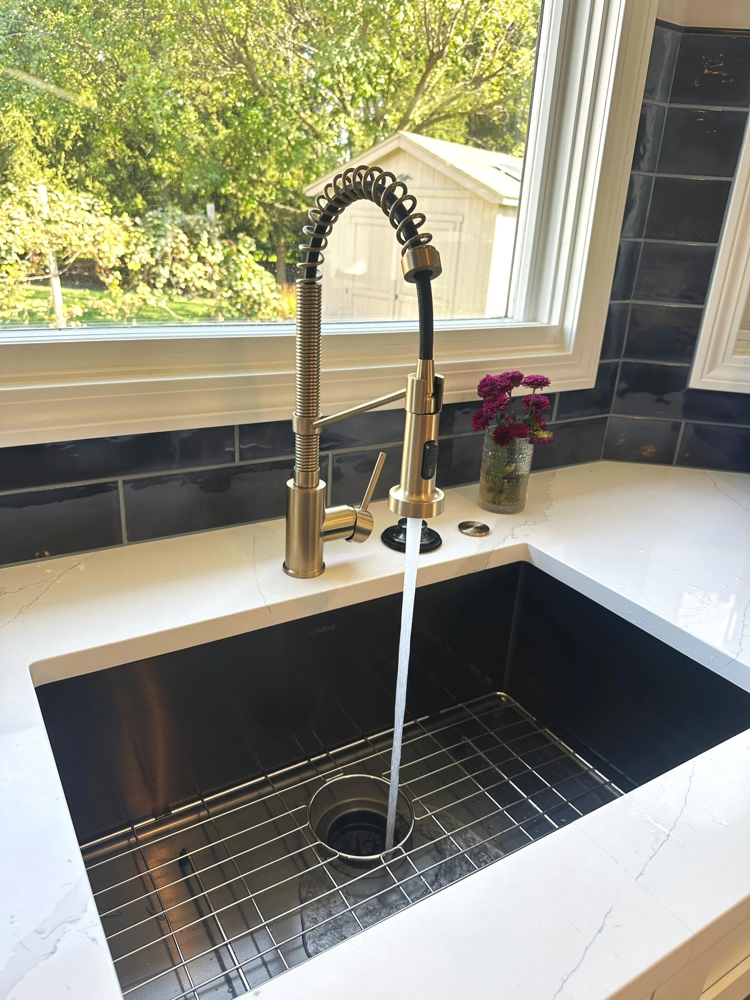 Modern kitchen faucet installed by Universal Plumbing & Sewer as part of a kitchen plumbing fixture upgrade.
