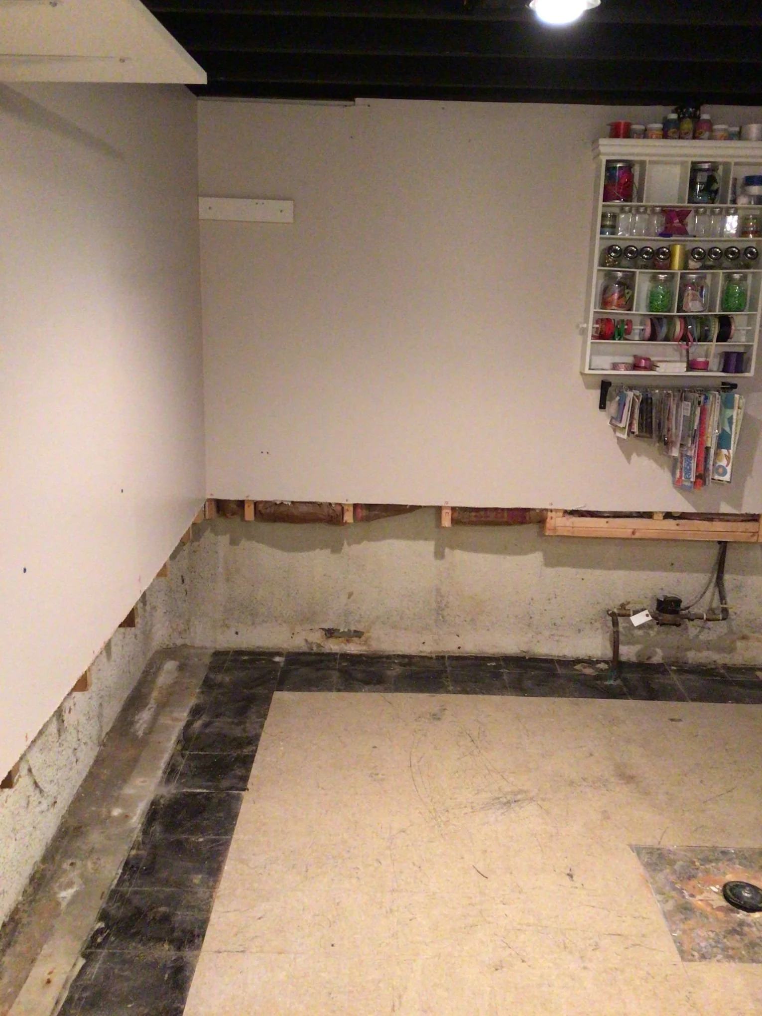 Refinished basement in Sterling Heights after waterproofing system installation and wall restoration.