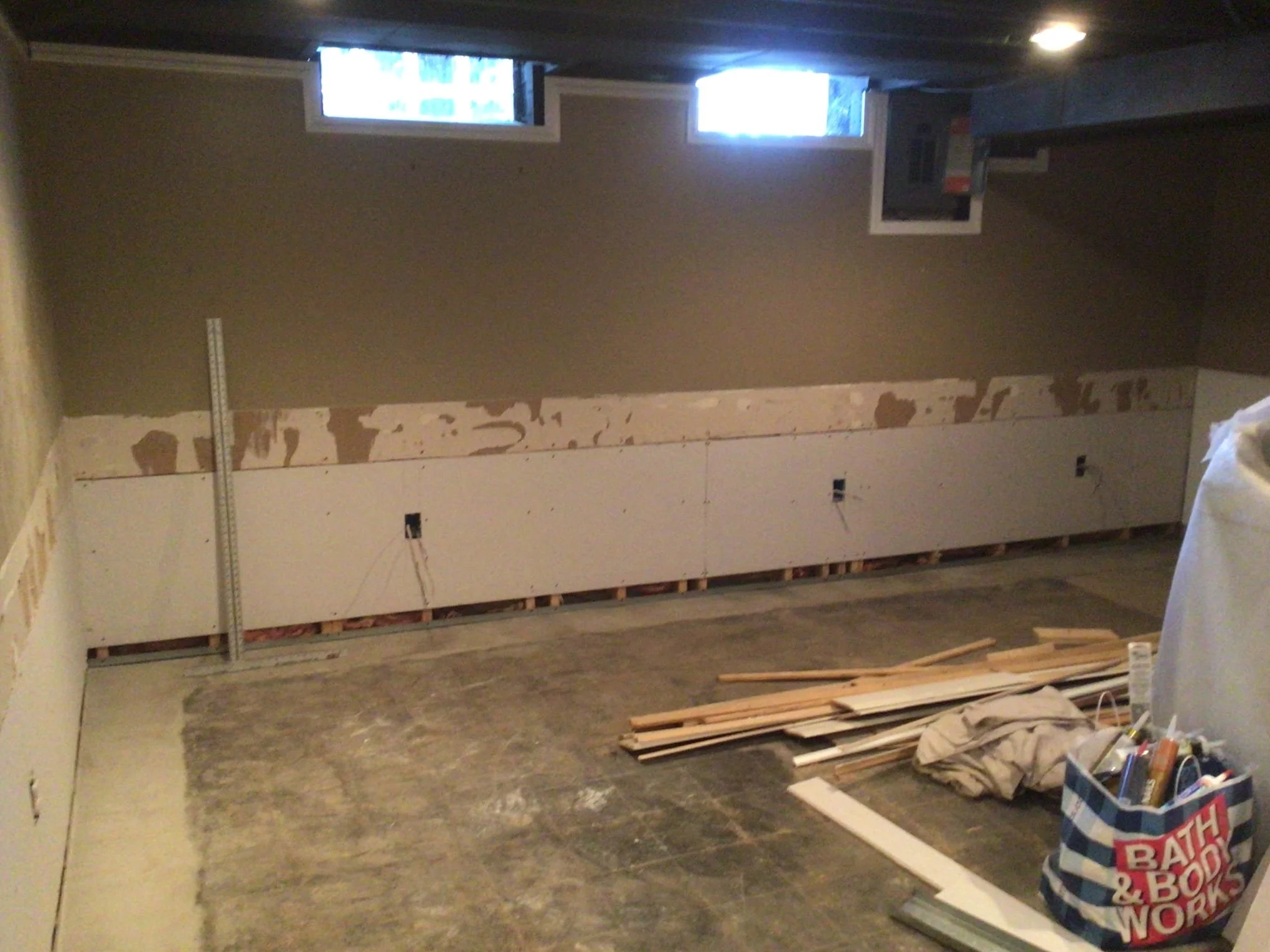 Refinished basement in Sterling Heights after waterproofing system installation and wall restoration.