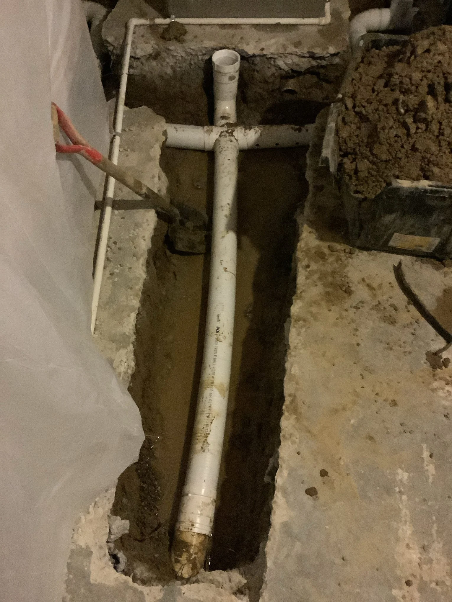 Custom basement drainage system installation in Rochester Hills, Michigan designed to collect groundwater and prevent basement flooding.