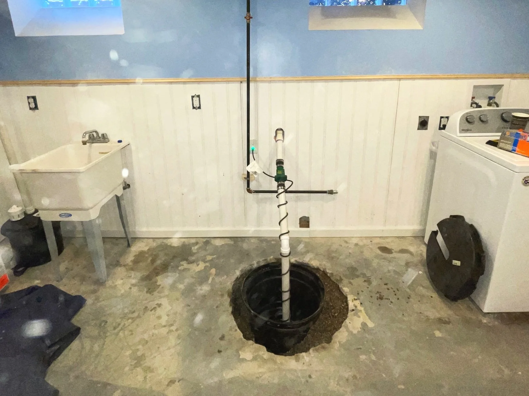 Basement waterproofing system with sump pump installation and interior drainage designed to prevent basement flooding and water damage.