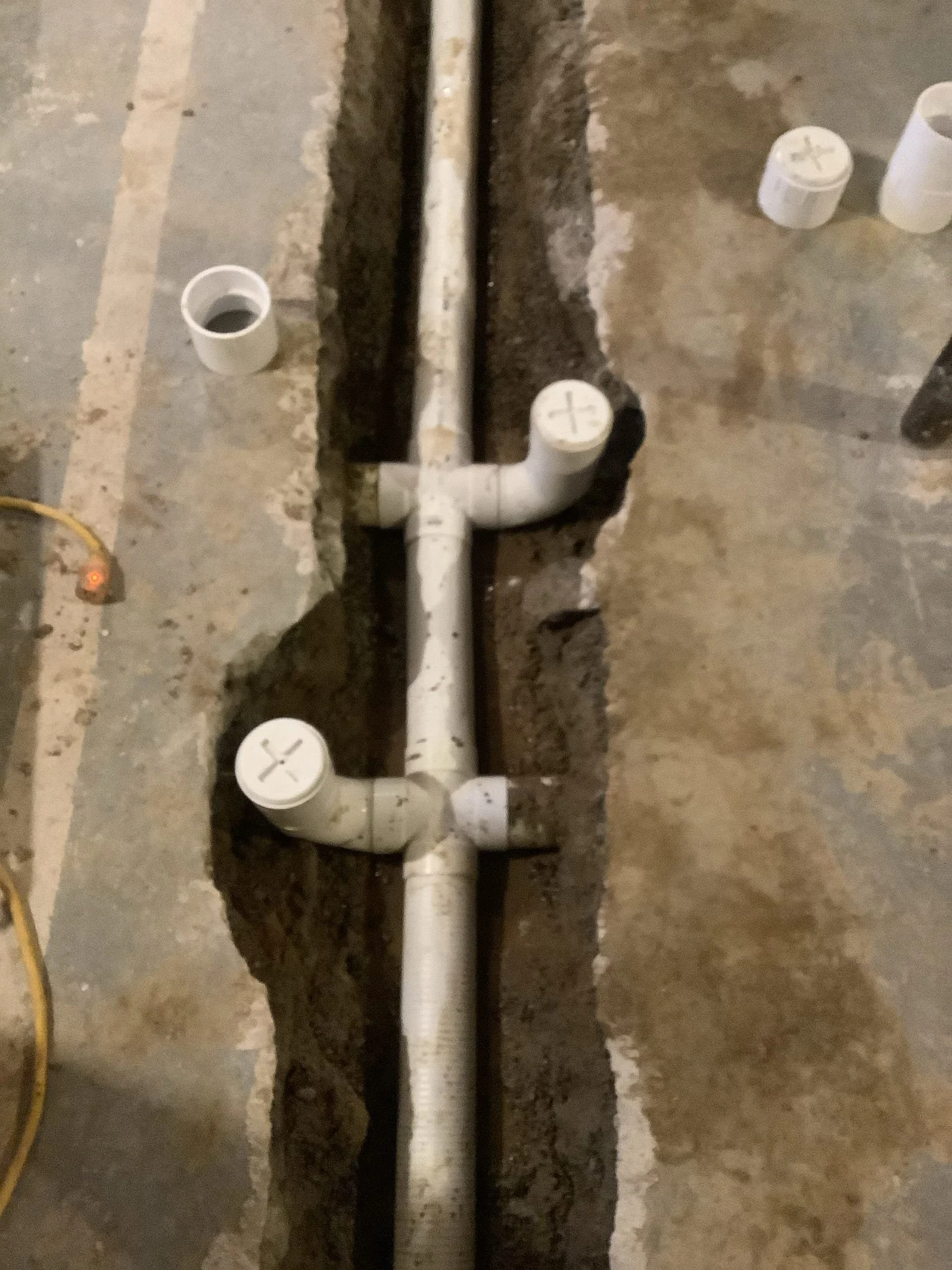 Basement in Rochester Hills experiencing water accumulation due to an ineffective non-perimeter drainage system.