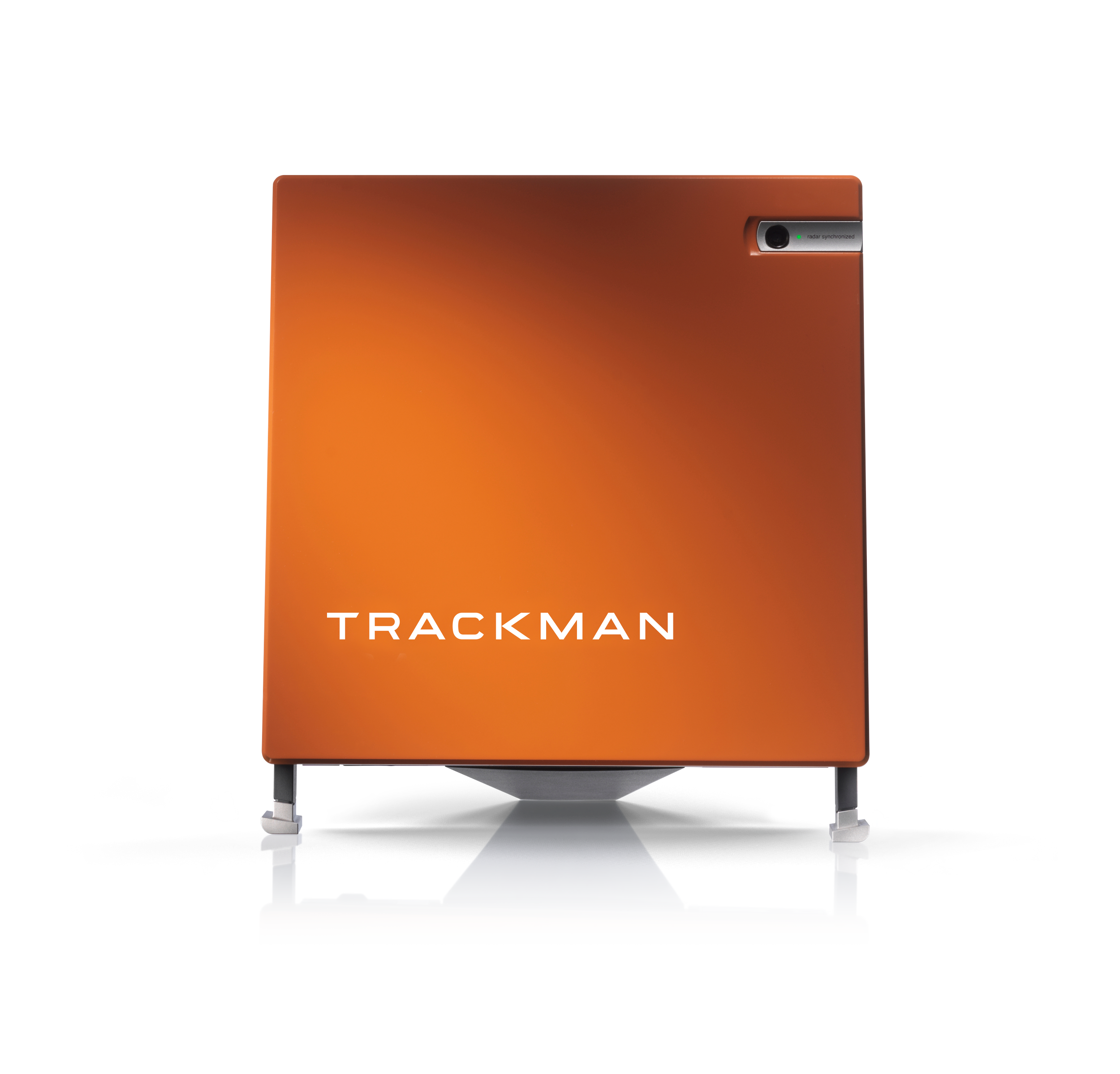 Orange electronic device labeled 'Trackman' with a camera and sensor on the top right corner, supported by a stand.