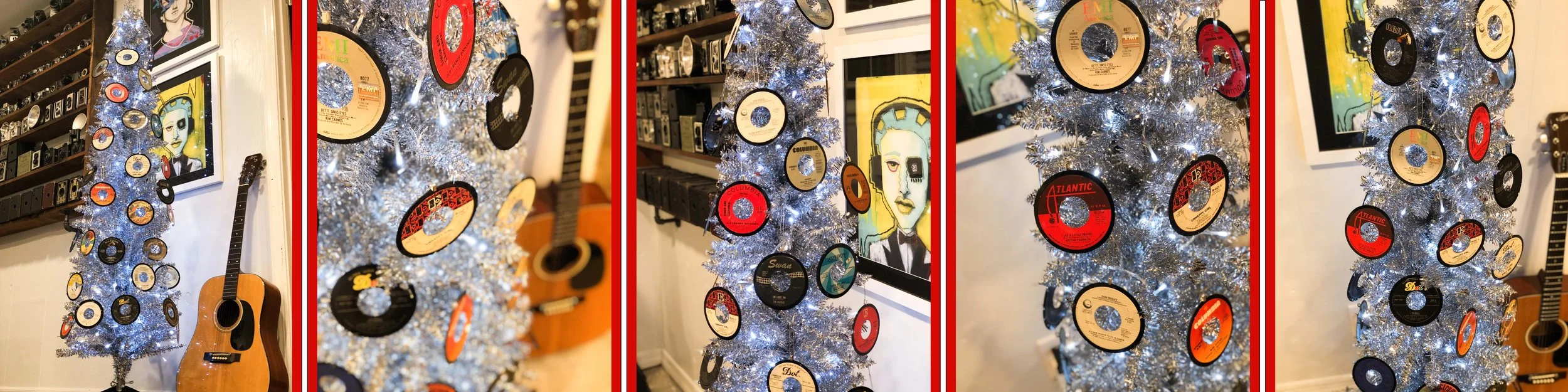 Christmas tree decorated with vinyl records, surrounded by a guitar and art pieces on the wall.