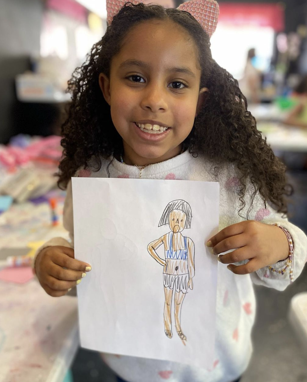 Young girl showcasing her fashion design