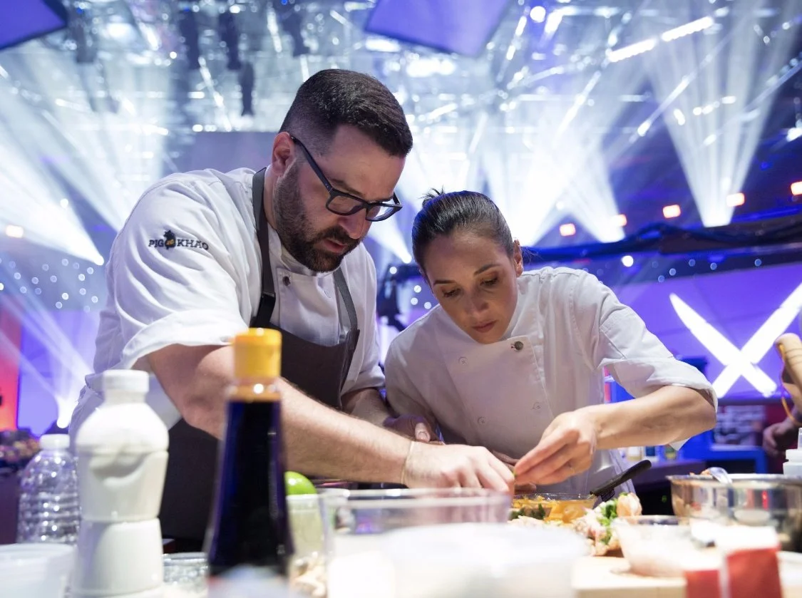 Leah Cohen and Ben Byruch plating a dish during a TV cooking competition