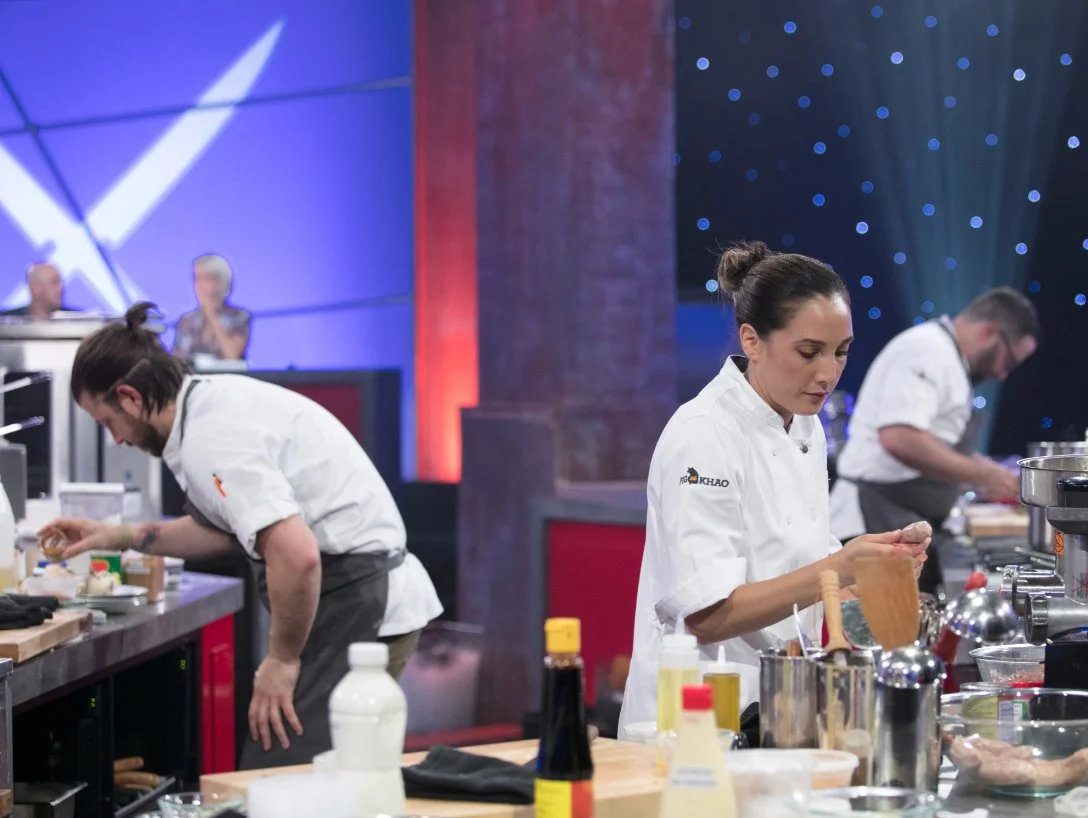 Leah Cohen cooking at her station during a TV cooking competition