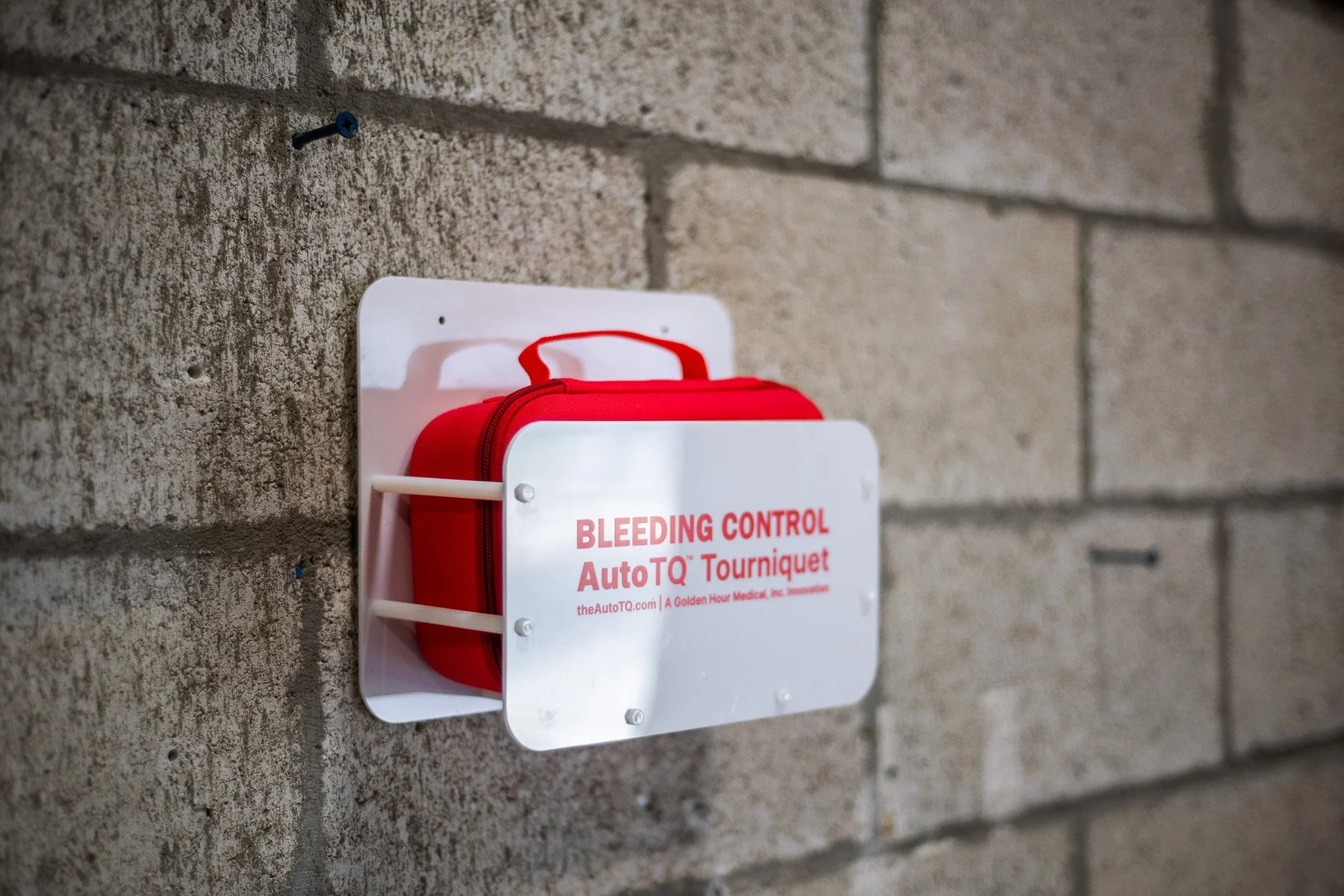 AutoTQ kit in a public access stop the bleed kit on a wall