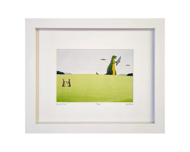 A framed illustration of a large cartoonish crocodile standing upright in a green field, holding a mirror, with two smaller rabbits sitting nearby and a few clouds in the sky.