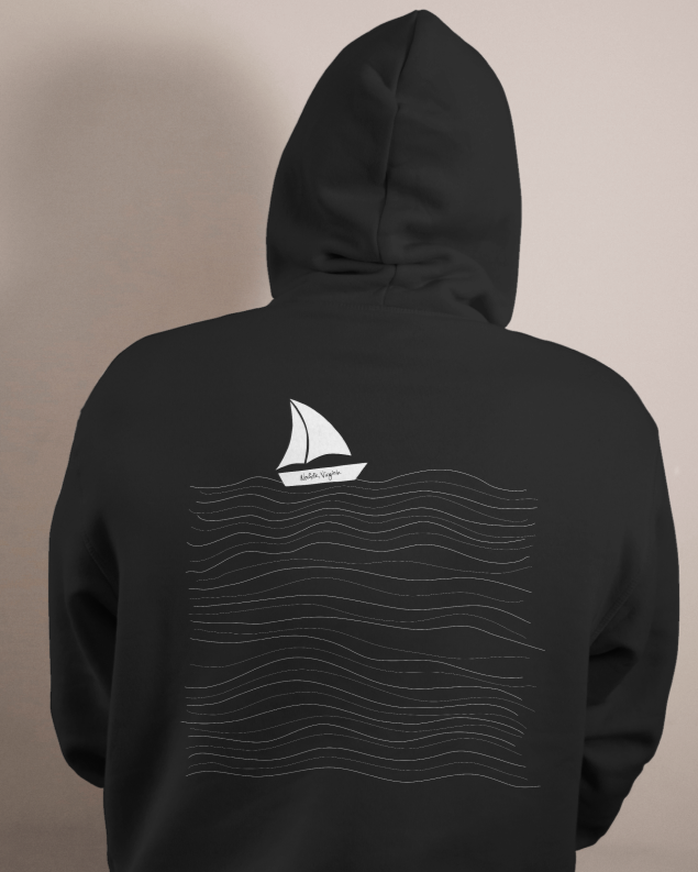 Back of a person wearing a black hoodie with a white sailboat and wavy lines design on the back