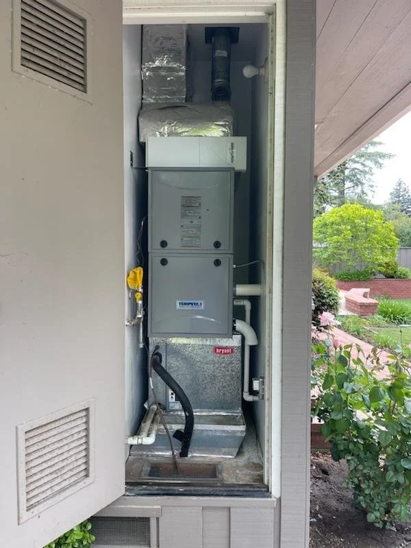 Residential gas furnace maintenance in Redwood City featuring a dedicated easy-access filter box installed directly above the furnace unit for simplified homeowner filter changes.