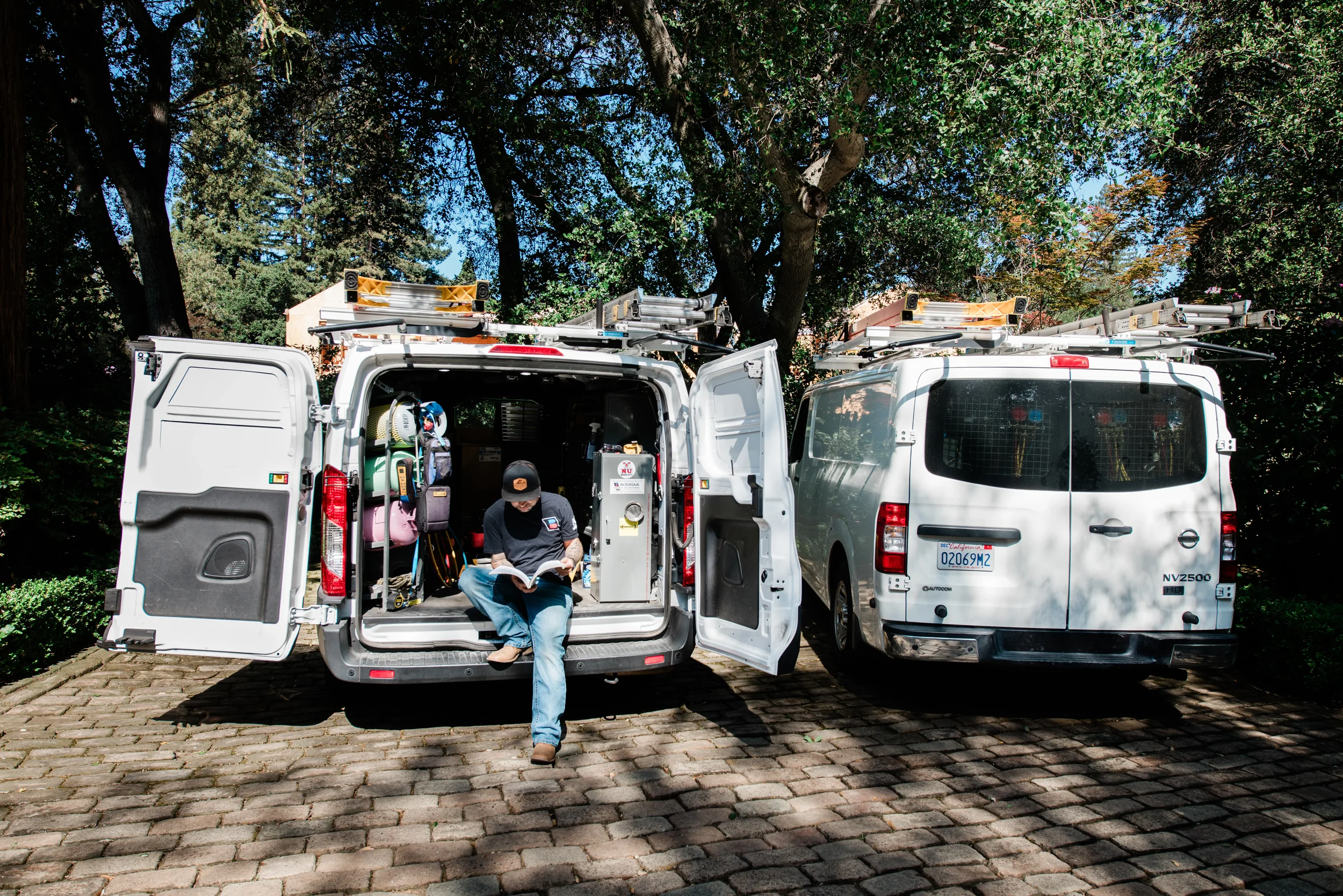 Two fully-equipped Bodnar HVAC service vans on-site in Redwood City, ready for residential heating and air conditioning installation and repair.