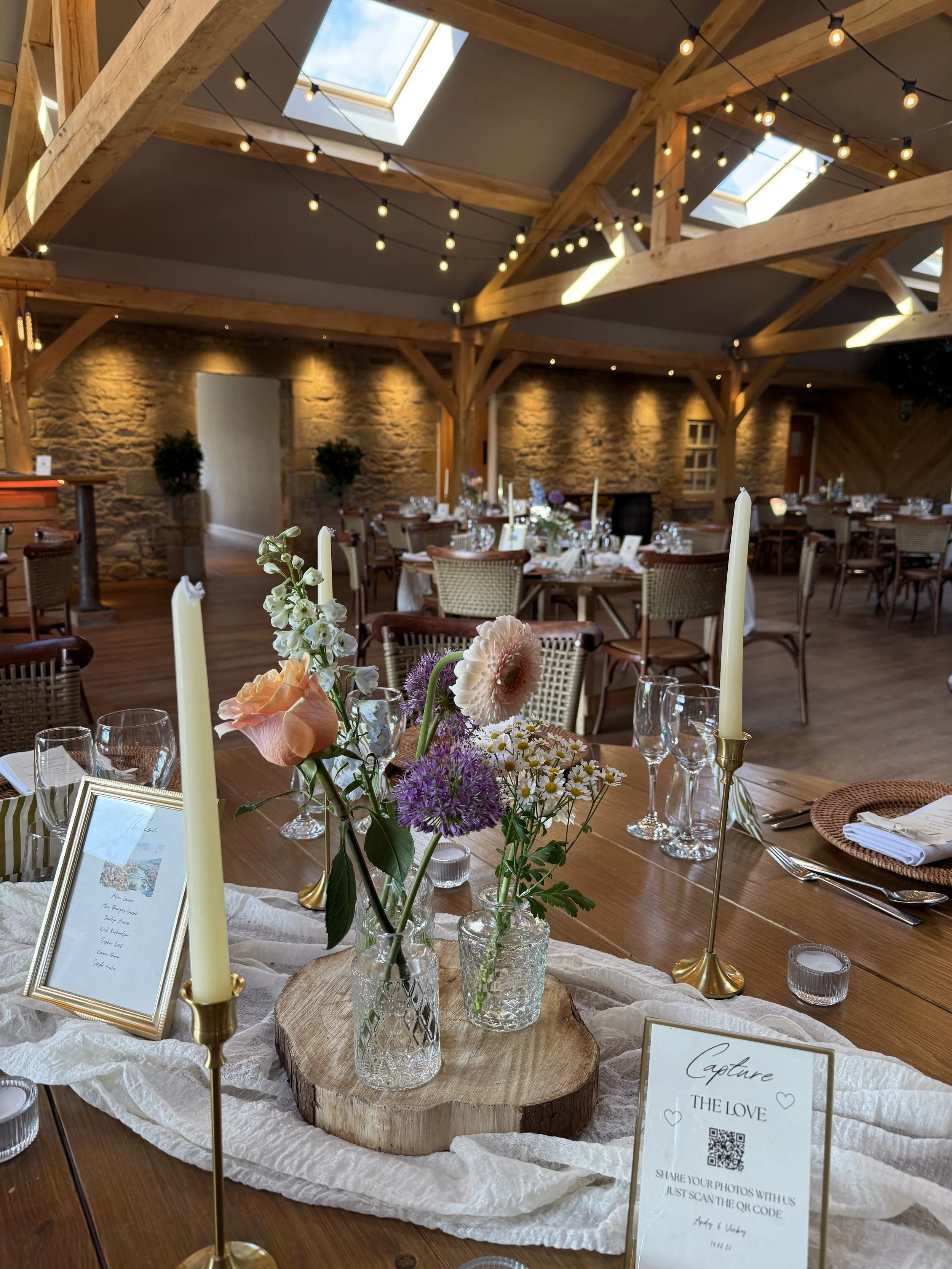 Delicate spring-pastel bud vases and complimentary candles