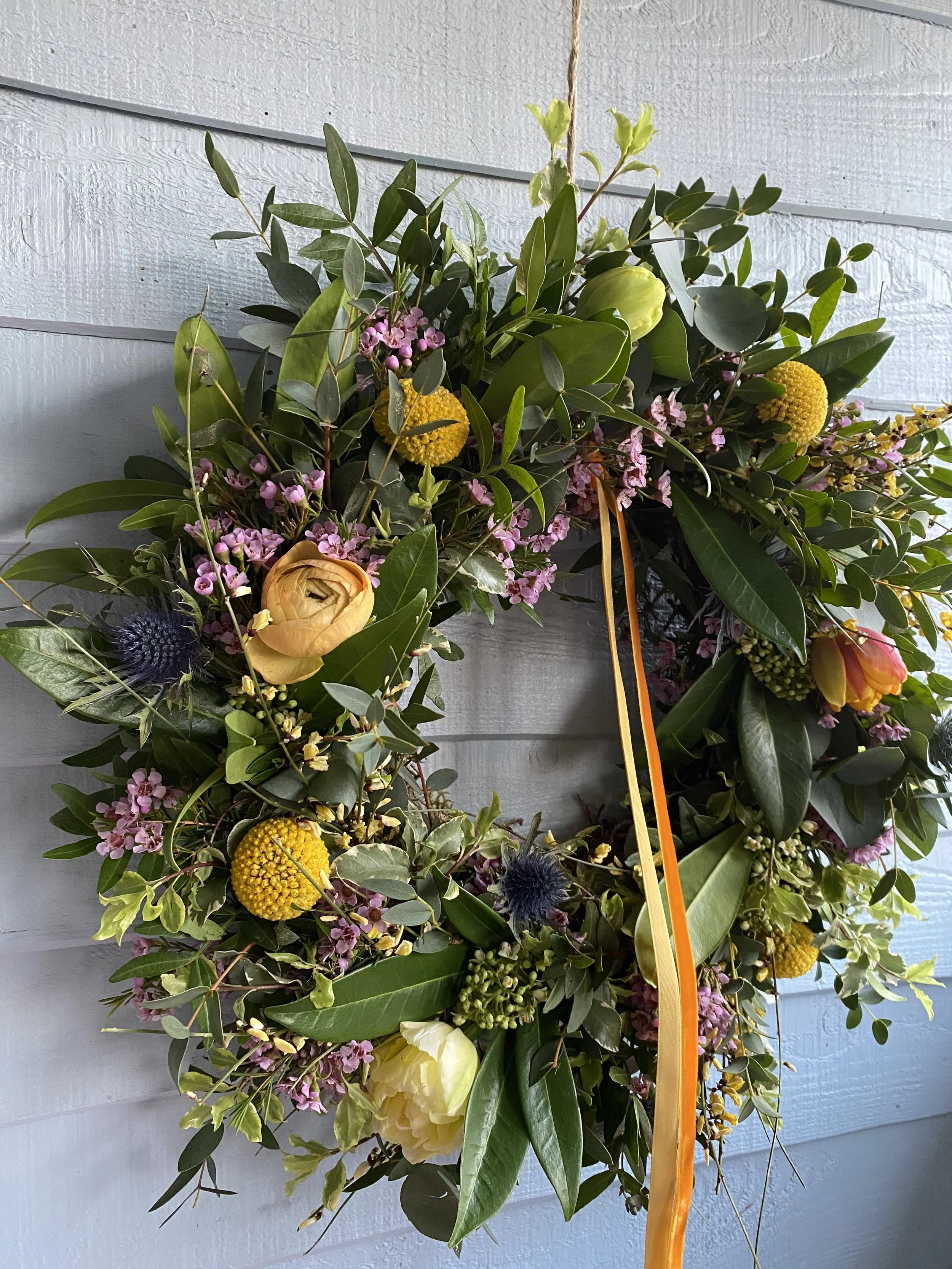 An image of a spring wreath in yellow and pinks