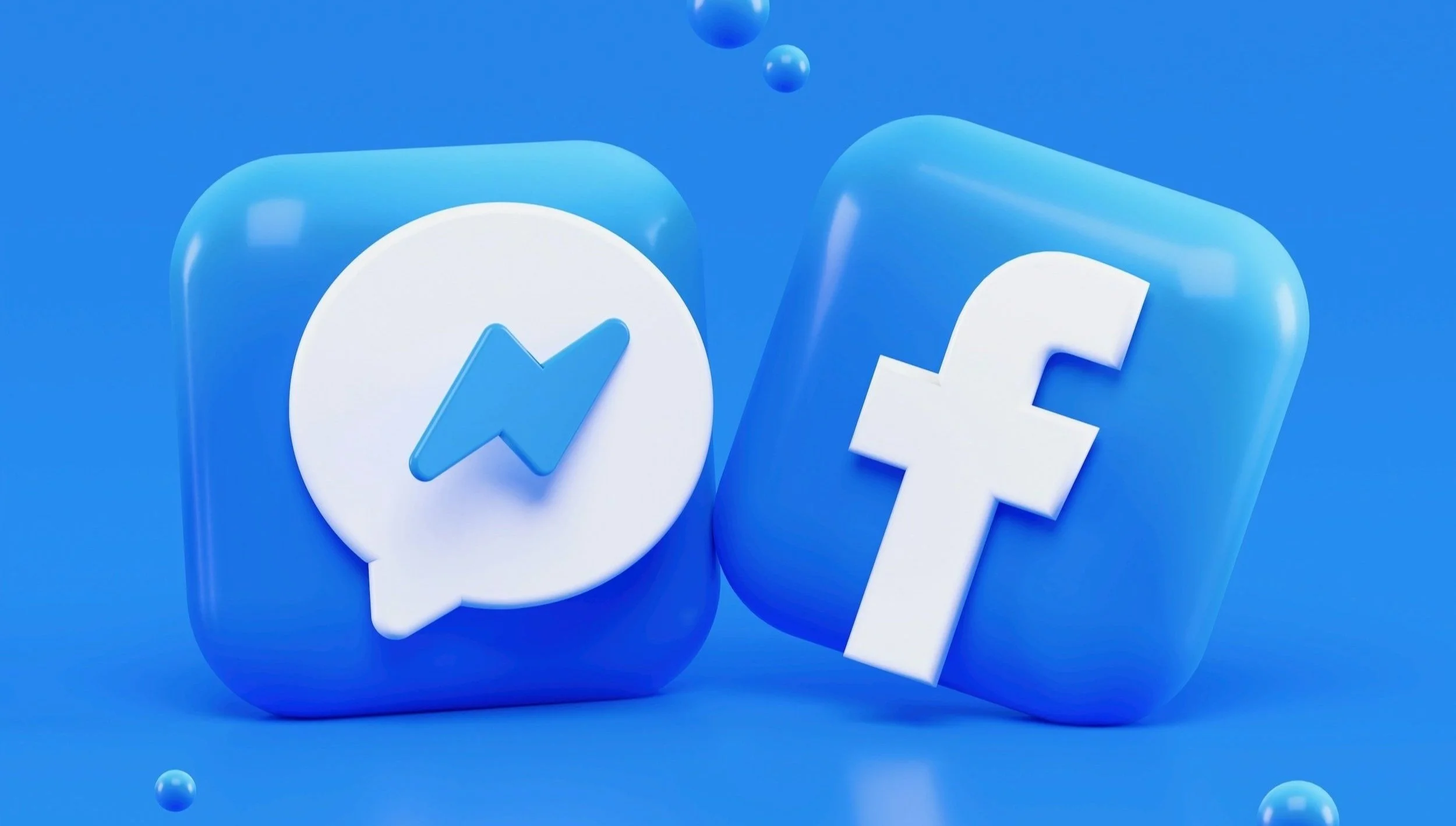 Icons of Facebook and Messenger in blue, three-dimensional style on a blue background.