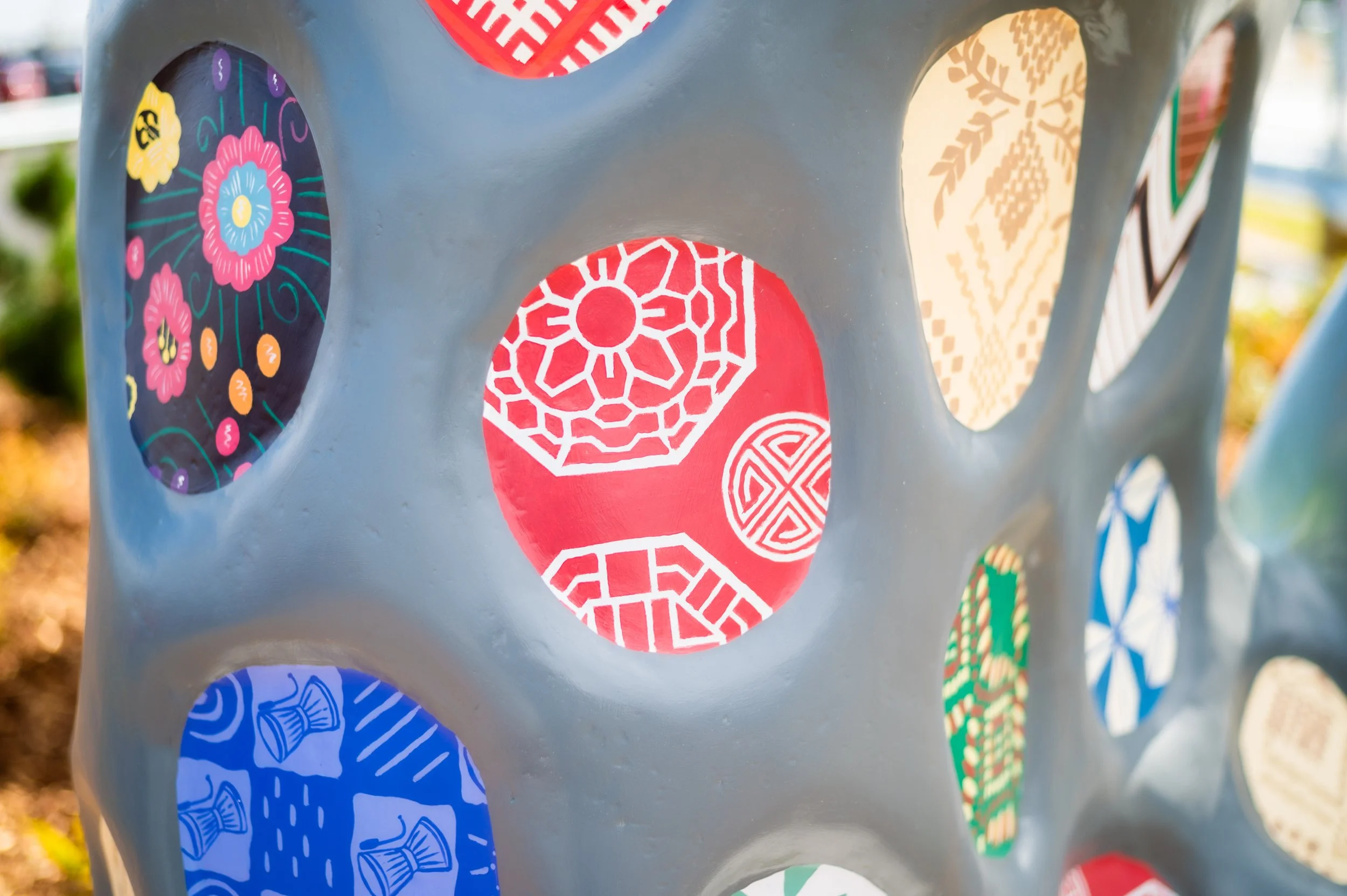 Close-up of a mitten sculpture showing various patterns in circles.