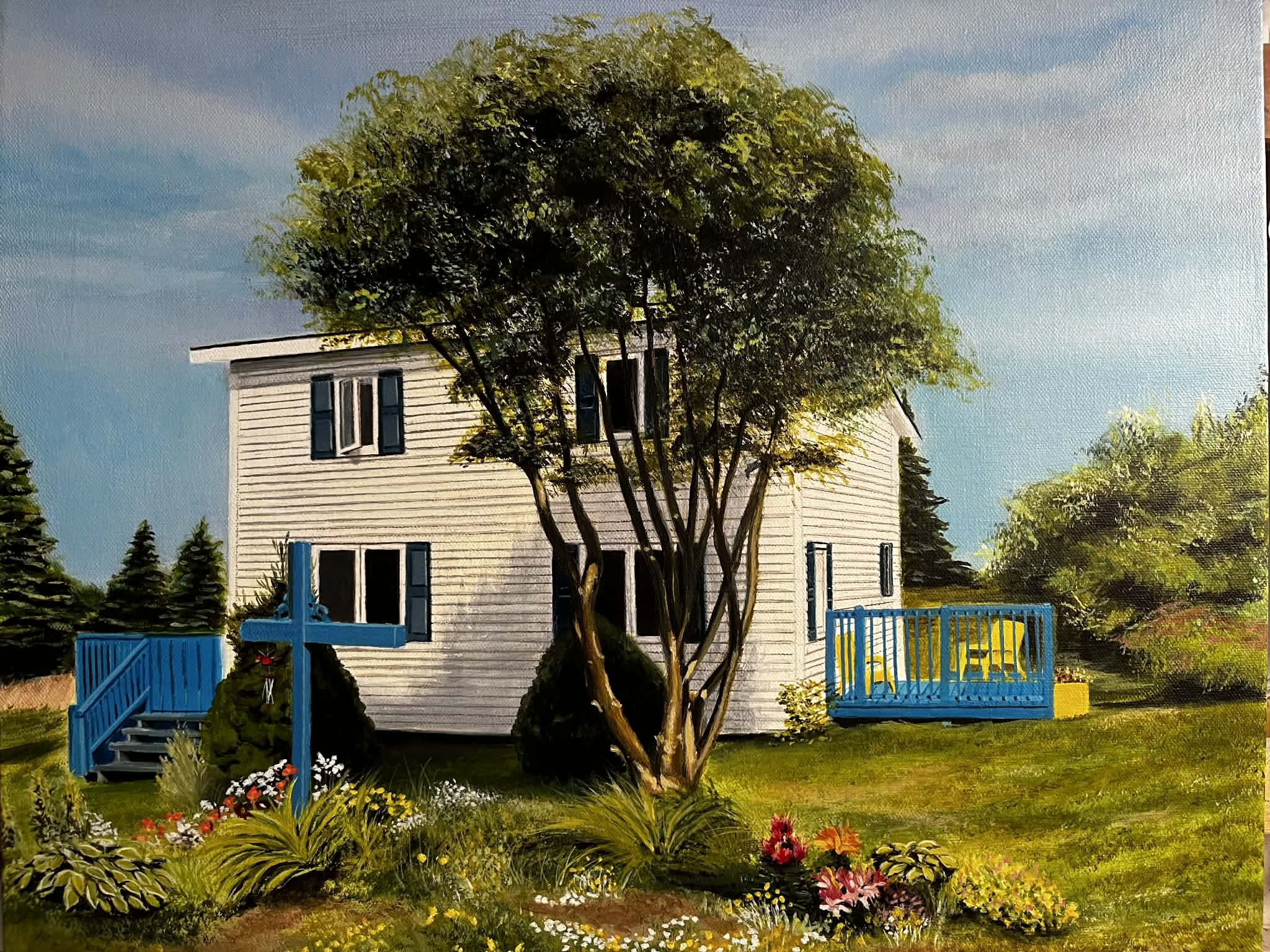 A painting showing a white, two-story house with blue trim, with blue stairs leading to a patio on the left and another blue deck on the right with yellow chairs. There are flowers in front of a large tree in front of the house.