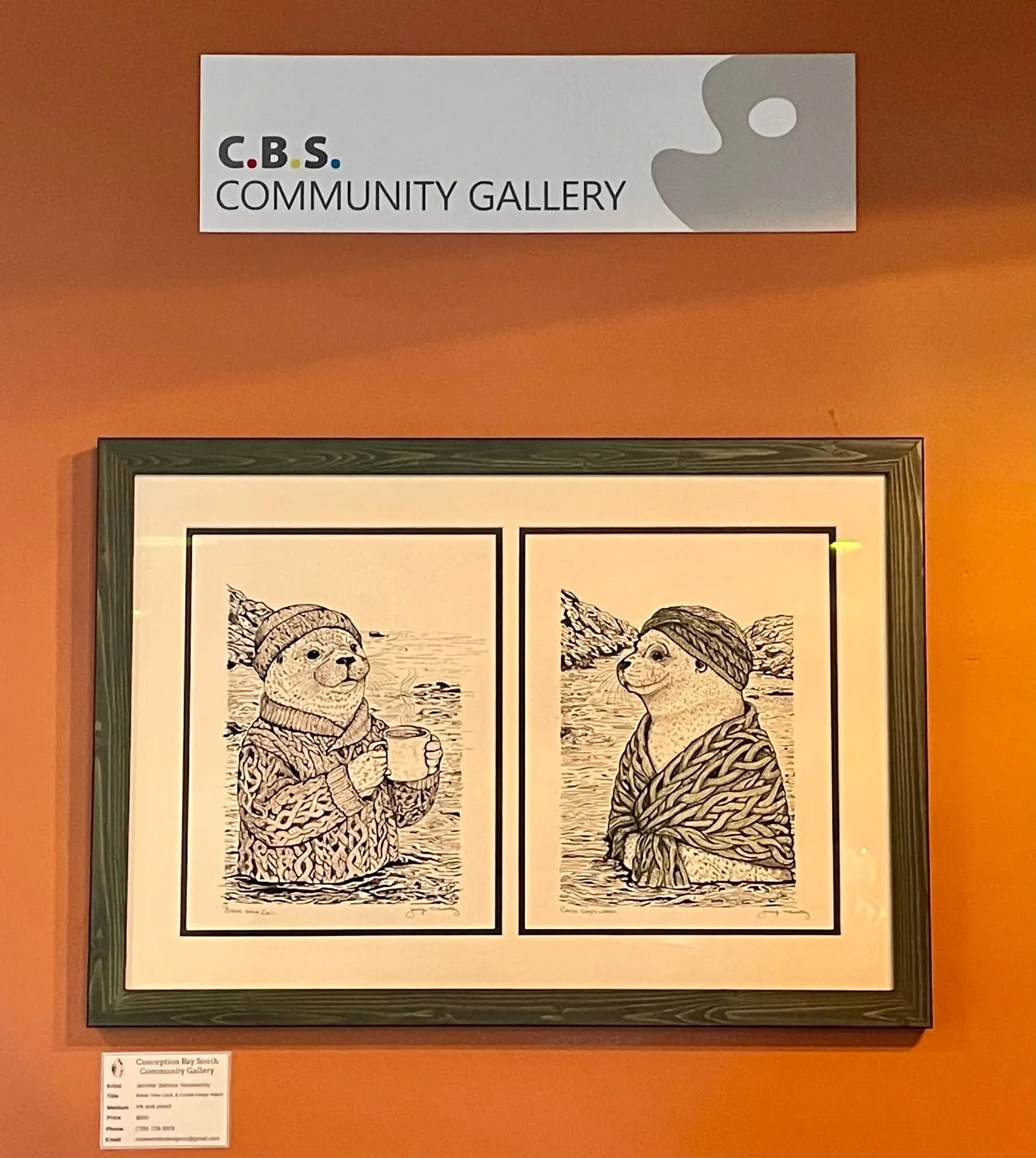 A painting with two panels featuring seals. The one on the left is sitting in the ocean wearing a toque and sweater holding a coffee cup, while the one on the right is sitting in the ocean wearing a head wrap and shawl. Below is a small info card.