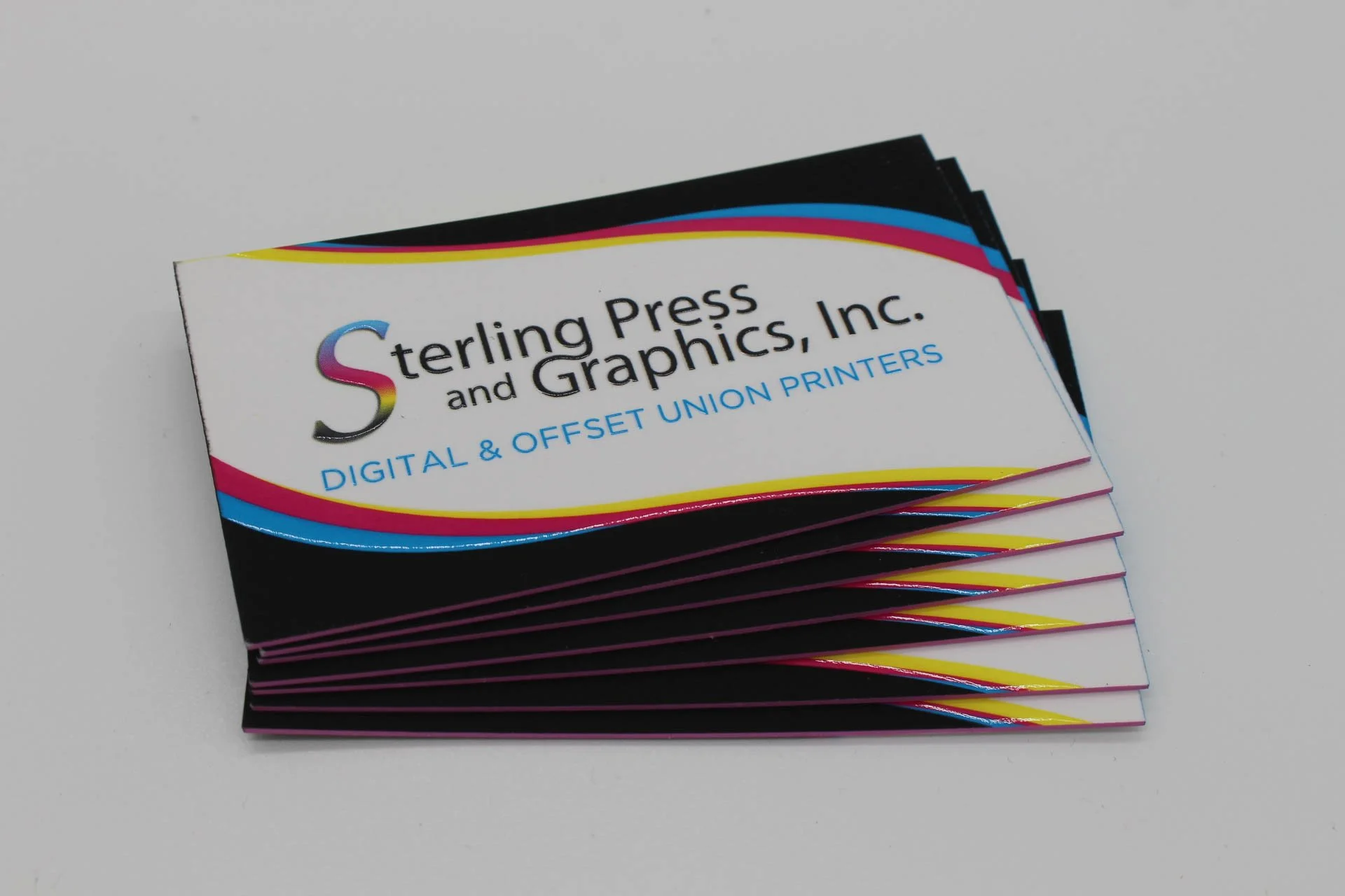 Custom Printed Business Cards for a Union Printing Company fanned out to show their black painted edge