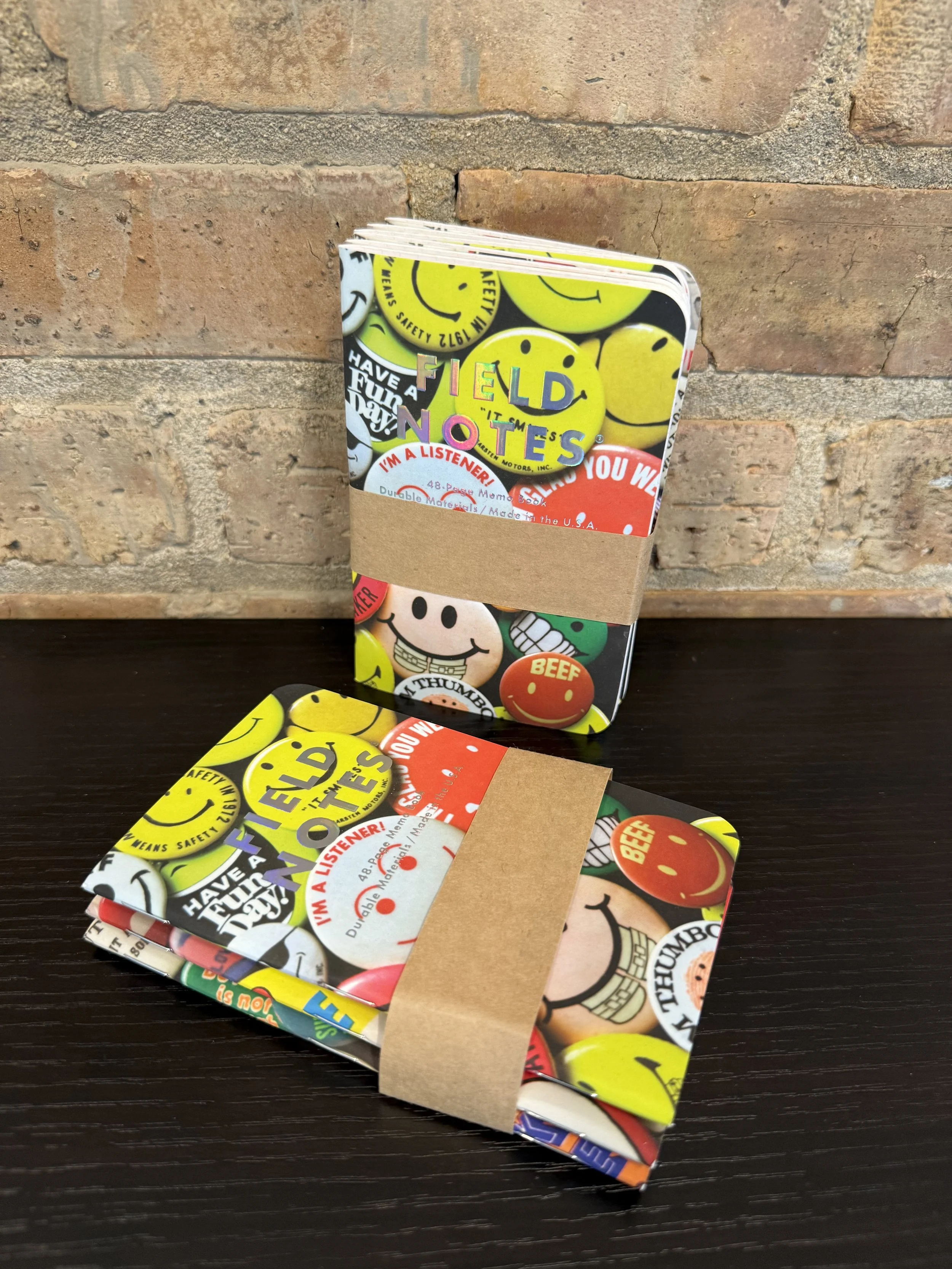 Custom Notepads for Field Notes featuring full-color printed smiley faces in bright colors