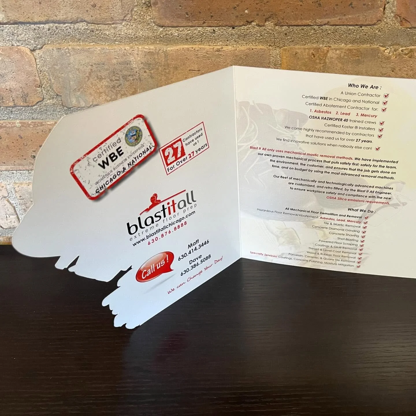 The inside cover of a Blastitall Extreme Floor Prep Custom Brochure with a Custom Shaped front cover contour cut in the same of a construction hat, work boots and gloves.