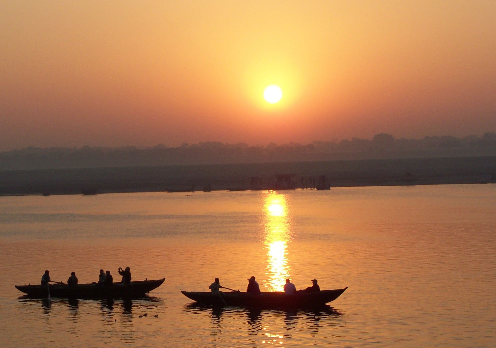 Photo of boats on the Ganges river at sunset