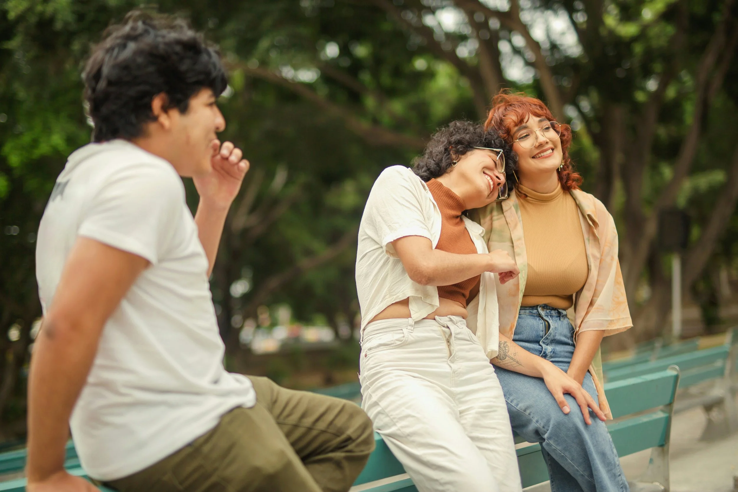 Three adults hang out and are content in each other's presence 