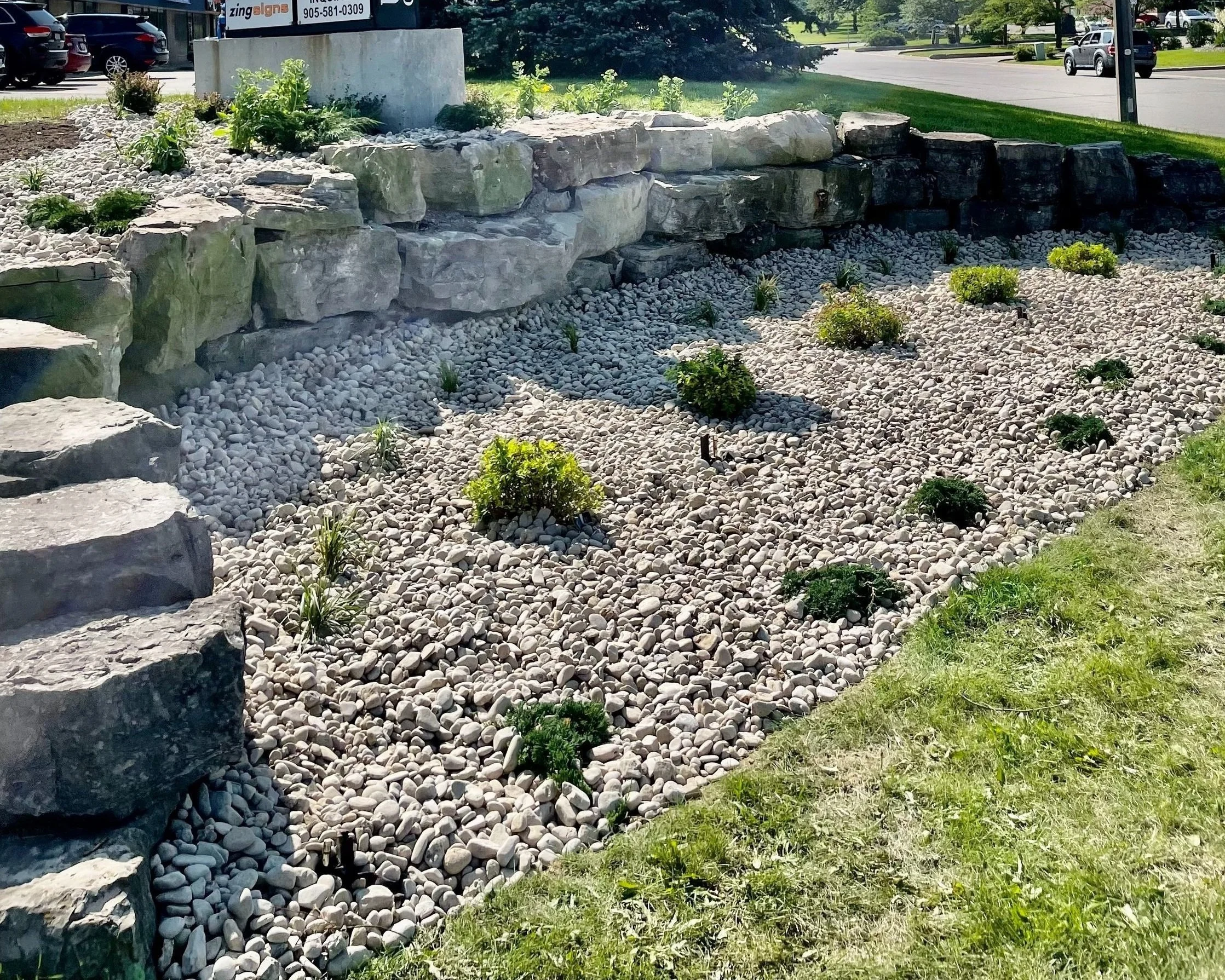 Calgary rock garden with boulders and small shrubs