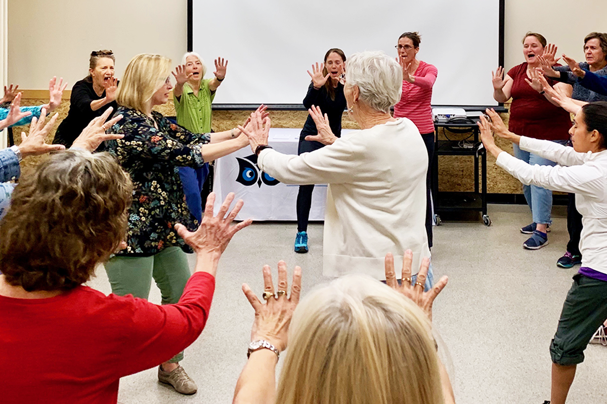 Circle of women practicing self defense_.png