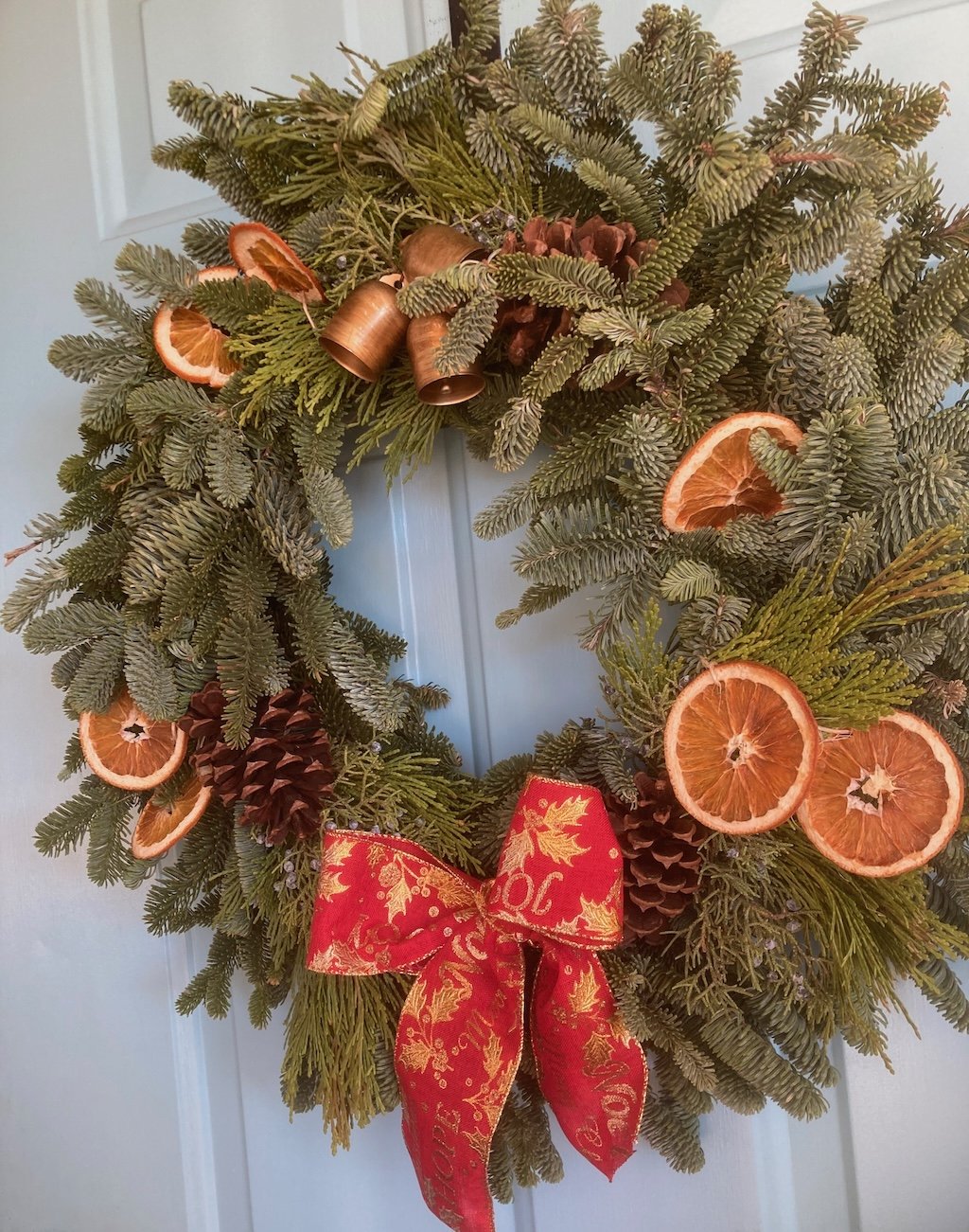 Wreath with dried oranges and red bow.jpeg