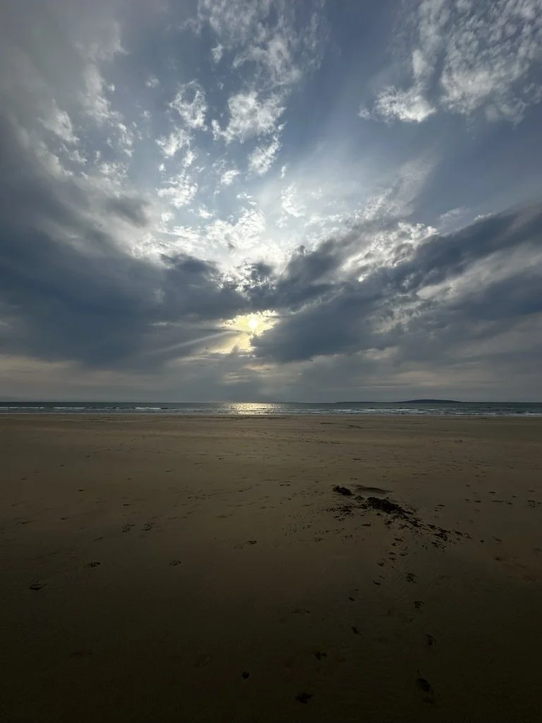 Wide beach beneath dramatic clouds