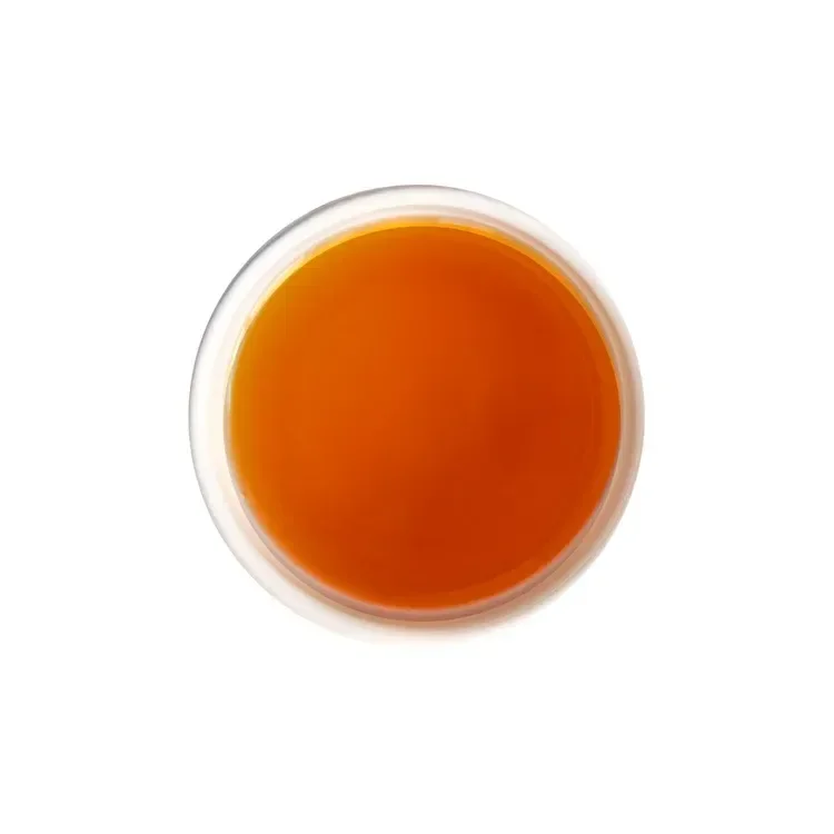 Brewed Earl Grey tea with bright ruby-red liquor and citrus aroma.