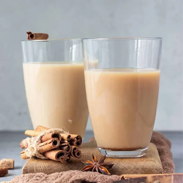 Creamy Assam milk tea served with cinnamon sticks and star anise for a cozy, spiced touch.