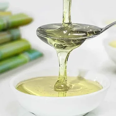 Cane sugar syrup pouring from a bottle — clear and ideal for tea brewing and automated dispensers