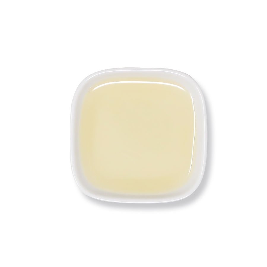 Top view of lemon syrup – smooth texture and translucent yellow hue.