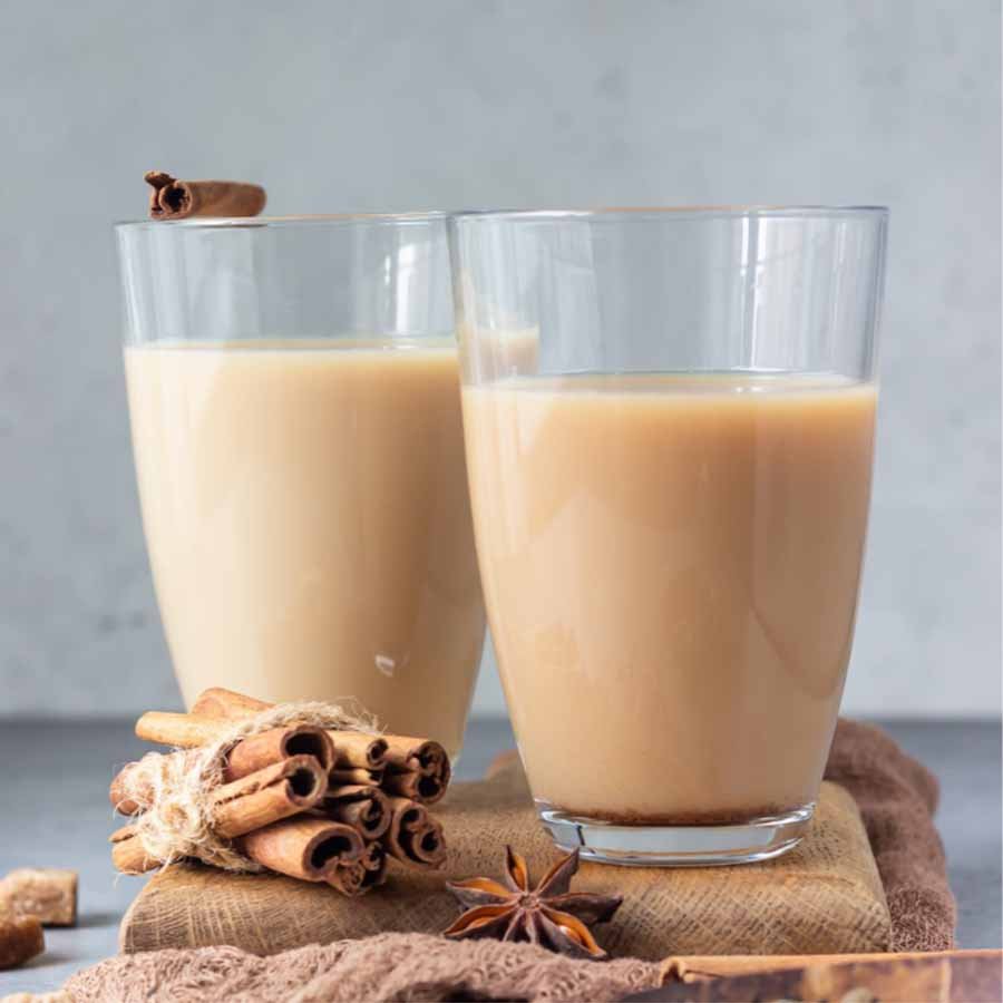 Creamy Assam milk tea served with cinnamon sticks and star anise for a cozy, spiced touch.