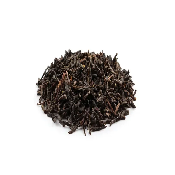 Dried Assam black tea leaves with twisted shape and dark reddish-brown tone.