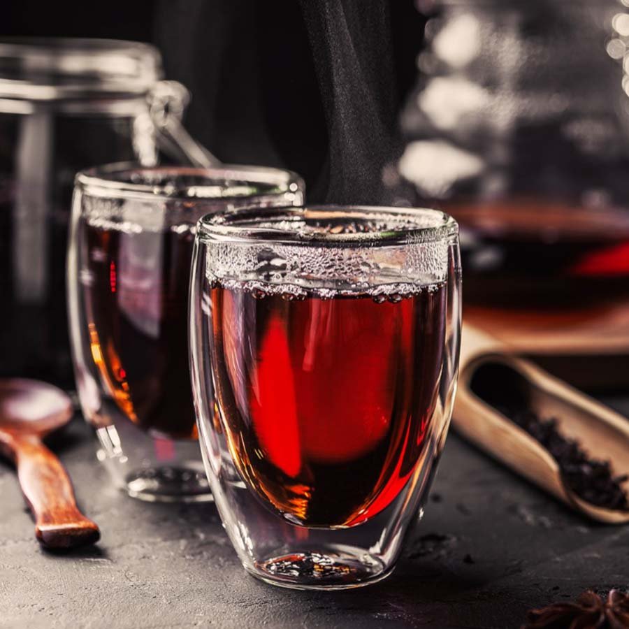 Amber Da Hong Pao tea in glass cup, showcasing rich and elegant flavor.