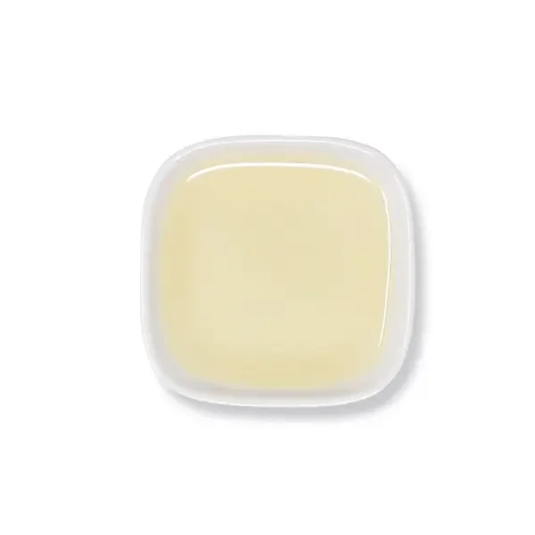 Top view of lemon syrup – smooth texture and translucent yellow hue.